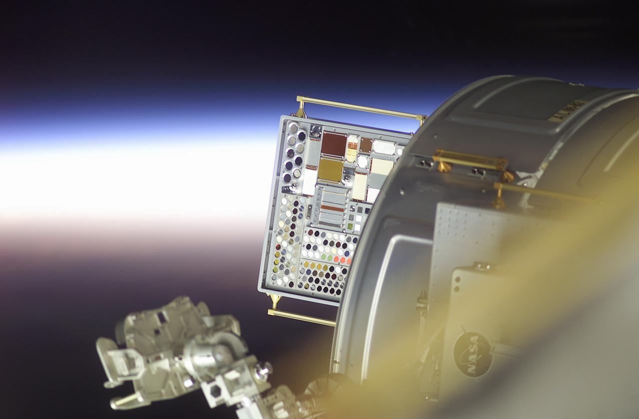 Backdropped by a sunrise, the newly installed Materials International Space Station Experiment (MISSE) is visible on this image. MISSE would expose 750 material samples for about 18 months and collect information on how different materials weather the space environment. The objective of MISSE is to develop early, low-cost, non-intrusive opportunities to conduct critical space exposure tests of space materials and components plarned for use on future spacecraft. The experiment was the first externally mounted experiment conducted on the International Space Station (ISS) and was installed on the outside of the ISS Quest Airlock during extravehicular activity (EVA) of the STS-105 mission. MISSE was launched on August 10, 2001 aboard the Space Shuttle Orbiter Discovery.