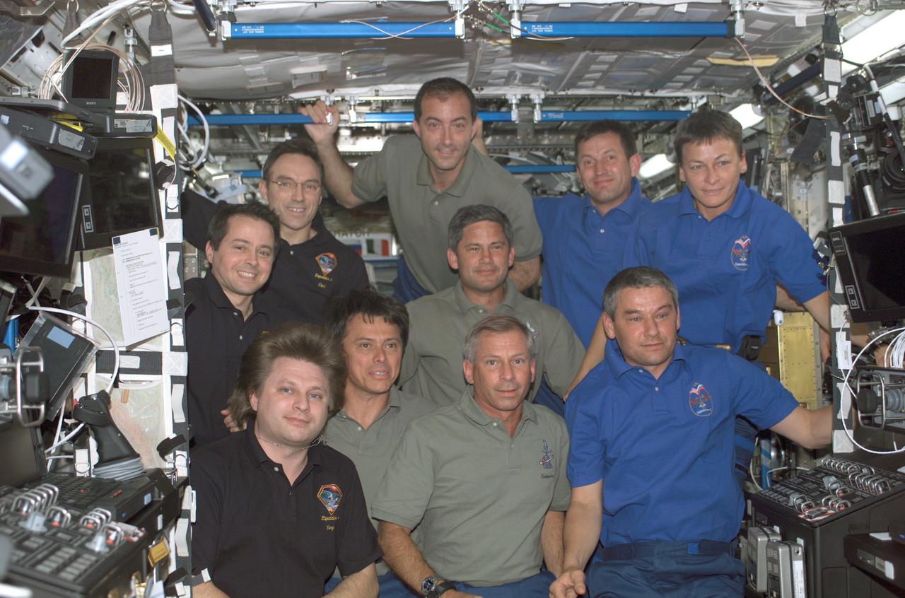 Huddled together in the Destiny laboratory of the International Space Station (ISS) are the Expedition Four crew (dark blue shirts), Expedition Five crew (medium blue shirts) and the STS-111 crew (green shirts). The Expedition Four crewmembers are, from front to back, Cosmonaut Ury I. Onufrienko, mission commander; and Astronauts Daniel W. Bursch and Carl E. Waltz, flight engineers. The ISS crewmembers are, from front to back, Astronauts Kerneth D. Cockrell, mission commander; Franklin R. Chang-Diaz, mission specialist; Paul S. Lockhart, pilot; and Philippe Perrin, mission specialist. Expedition Five crewmembers are, from front to back, Cosmonaut Valery G. Korzun, mission commander; Astronaut Peggy A. Whitson and Cosmonaut Sergei Y. Treschev, flight engineers. The ISS recieved a new crew, Expedition Five, replacing Expedition Four after a record-setting 196 days in space, when the Space Shuttle Orbiter Endeavour STS-111 mission visited in June 2002. Three spacewalks enabled the STS-111 crew to accomplish additional mission objectives: the delivery and installation of the Mobile Base System (MBS), which is an important part of the station's Mobile Servicing System allowing the robotic arm to travel the length of the station; the replacement of a wrist roll joint on the Station's robotic arm; and unloading supplies and science experiments from the Leonardo Multi-Purpose Logistics Module, which made its third trip to the orbital outpost. The STS-111 mission, the 14th Shuttle mission to visit the ISS, was launched on June 5, 2002 and landed June 19, 2002.