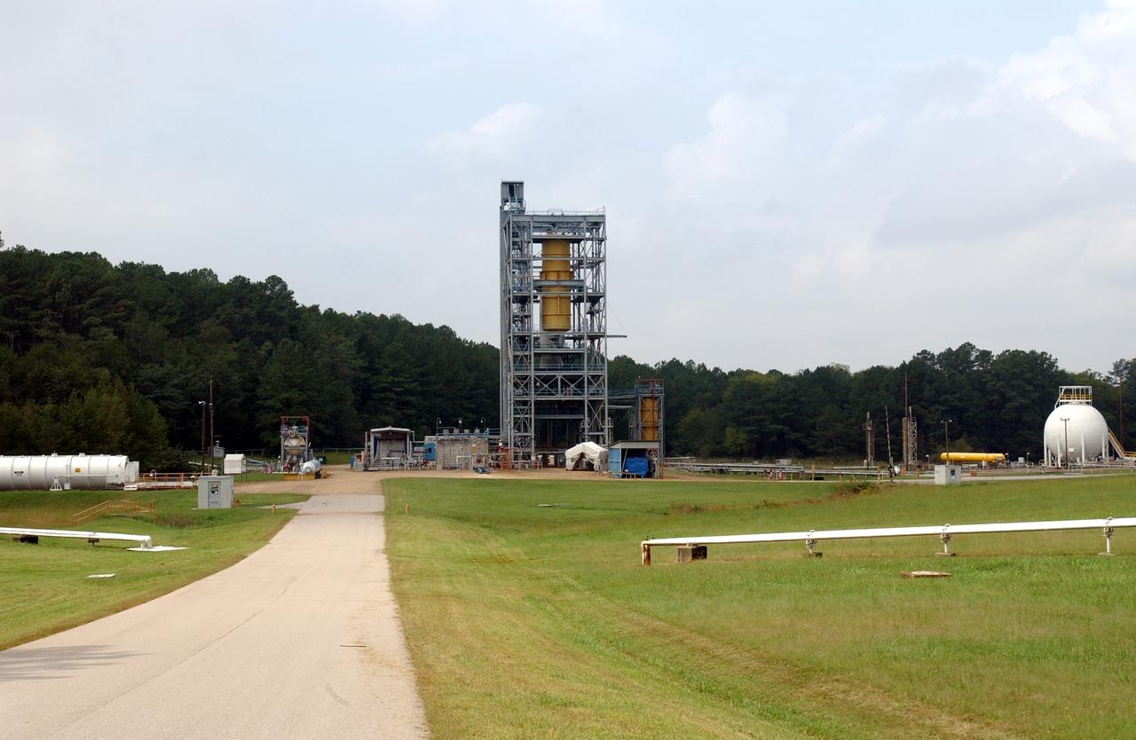 This is a ground level view of Test Stand 500 at the east test area of the Marshall Space Flight Center. Originally constructed in 1966, Test Stand 500 is a multipurpose, dual-position test facility. The stand was utilized to test liquid hydrogen/liquid oxygen turbopumps and combustion devices for the J-2 engine. One test position has a high superstructure with lines and tankage for testing liquid hydrogen and liquid oxygen turbopumps while the other position is adaptable to pressure-fed test programs such as turbo machinery bearings or seals. The facility was modified in 1980 to support Space Shuttle main engine (SSME) bearing testing.