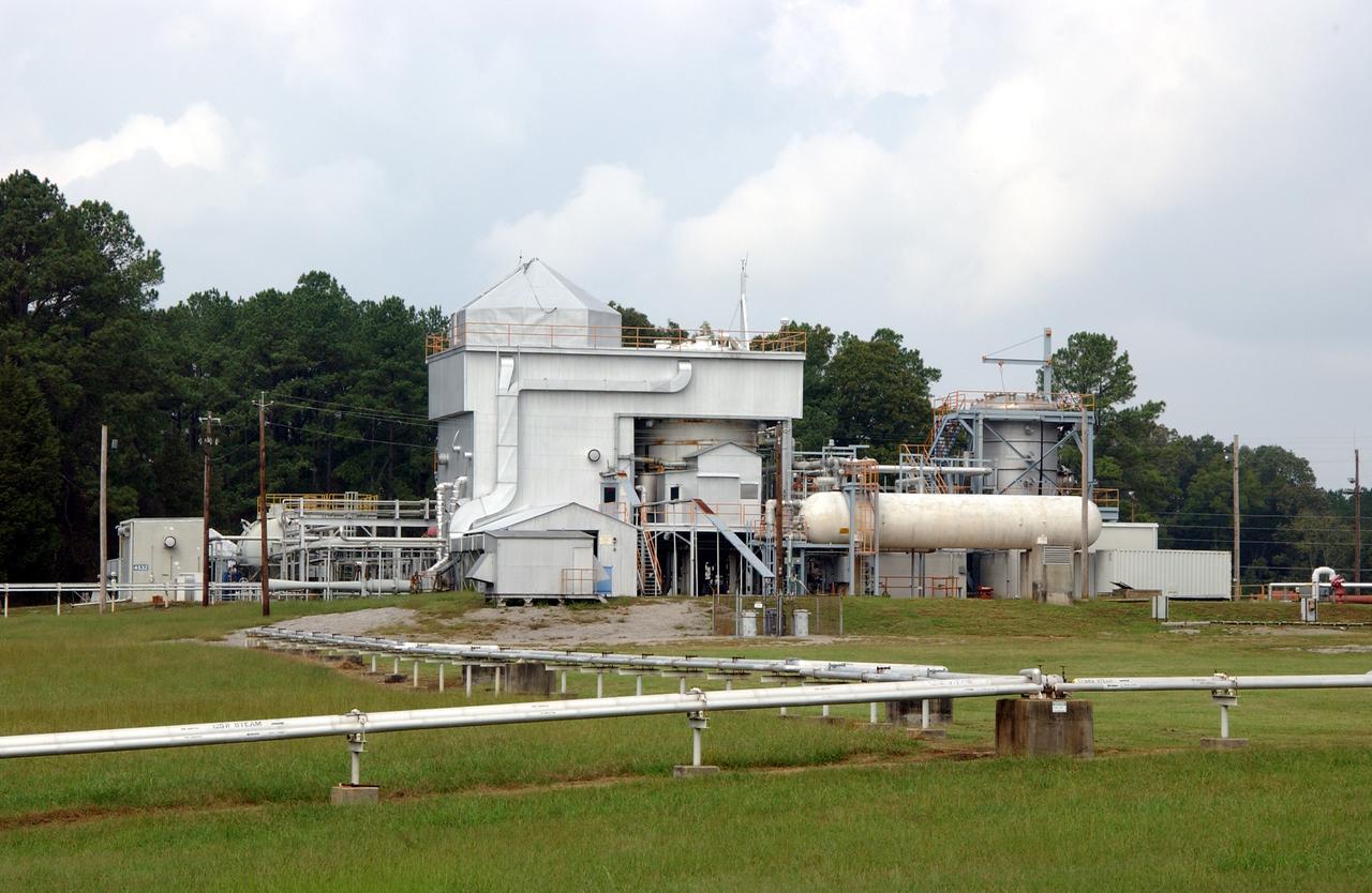 This is a ground level view of Test Stand 300 at the east test area of the Marshall Space Flight Center. Test Stand 300 was constructed in 1964 as a gas generator and heat exchanger test facility to support the Saturn/Apollo Program. Deep-space simulation was provided by a 1960 modification that added a 20-ft thermal vacuum chamber and a 1981 modification that added a 12-ft vacuum chamber. The facility was again modified in 1989 when 3-ft and 15-ft diameter chambers were added to support Space Station and technology programs. This multiposition test stand is used to test a wide range of rocket engine components, systems, and subsystems. It has the capability to simulate launch thermal and pressure profiles. Test Stand 300 was designed for testing solid rocket booster (SRB) insulation panels and components, super-insulated tanks, external tank (ET) insulation panels and components, Space Shuttle components, solid rocket motor materials, and advanced solid rocket motor materials.