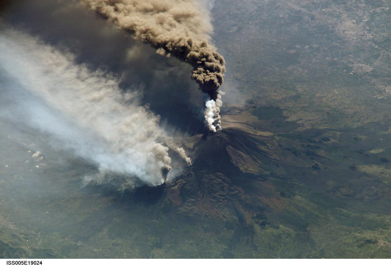 Expedition Five crew members aboard the International Space Station (ISS) captured this overhead look at the smoke and ash regurgitated from the erupting volcano Mt. Etna on the island of Sicily, Italy in October 2002. Triggered by a series of earthquakes on October 27, 2002, this eruption was one of Etna's most vigorous in years. This image shows the ash plume curving out toward the horizon. The lighter-colored plumes down slope and north of the summit seen in this frame are produced by forest fires set by flowing lava. At an elevation of 10,990 feet (3,350 m), the summit of the Mt. Etna volcano, one of the most active and most studied volcanoes in the world, has been active for a half-million years and has erupted hundreds of times in recorded history.