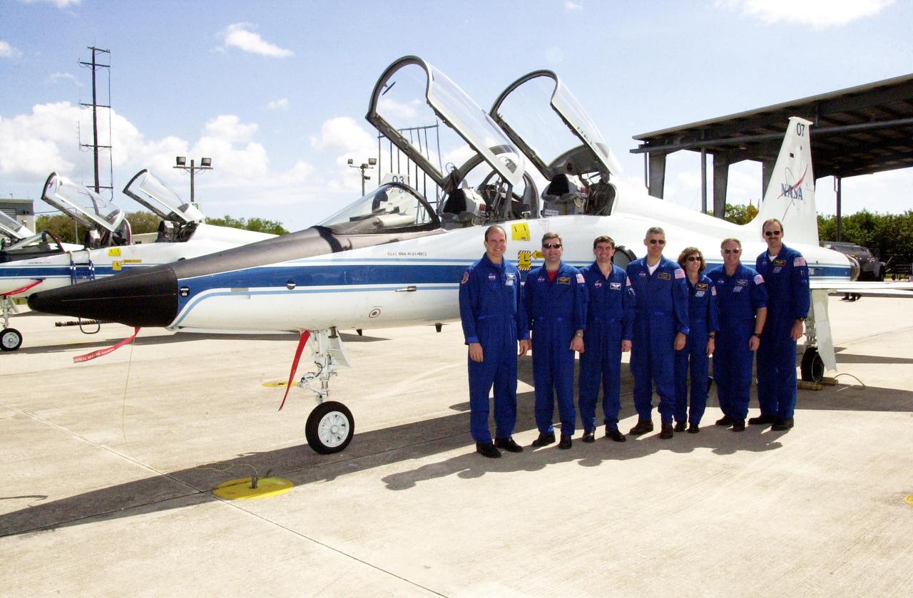 KENNEDY SPACE CENTER, FLA. --  The STS-110 crew poses in front of a T-38 jet aircraft at the Shuttle Landing Facility before departing for Houston. Standing left to right are Commander Michael Bloomfield, Pilot Stephen Frick and Mission Specialists Rex Walheim, Lee Morin, Ellen Ochoa, Jerry Ross and Steven Smith. The crew was at KSC for Terminal Countdown Demonstration Test activities that included payload familiarization and a simulated launch countdown.   Scheduled for launch April 4, the 11-day STS-110 mission will feature Space Shuttle Atlantis docking with the International Space Station (ISS) and delivering the S0 truss, the centerpiece-segment of the primary truss structure that will eventually extend over 300 feet