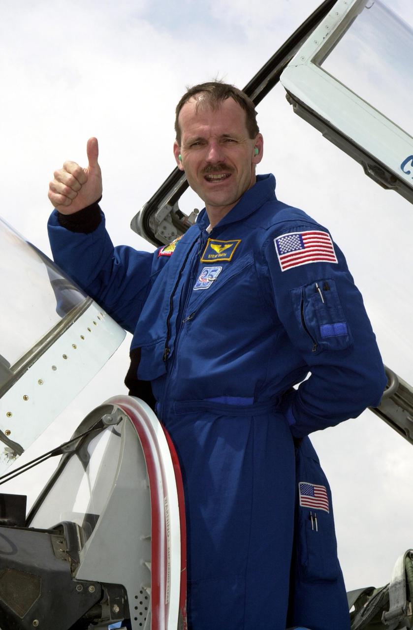 KENNEDY SPACE CENTER, FLA. --, STS-110 Mission Specialist Steven Smith gives a thumbs up after landing at the KSC Shuttle Landing Facility to prepare for launch April 4.  The mission will be his fourth Space Shuttle flight. Mission STS-110 is the 13th assembly flight to the International Space Station.  During four planned spacewalks, crew members will install the S0 Integrated Truss Structure (ITS), centerpiece of the orbiting International Space Station (ISS), at the center of the 10-truss, girderlike structure that will ultimately extend the length of a football field on the ISS.   The S0 truss will be attached to the U.S. Lab, 'Destiny,'  on the 11-day mission