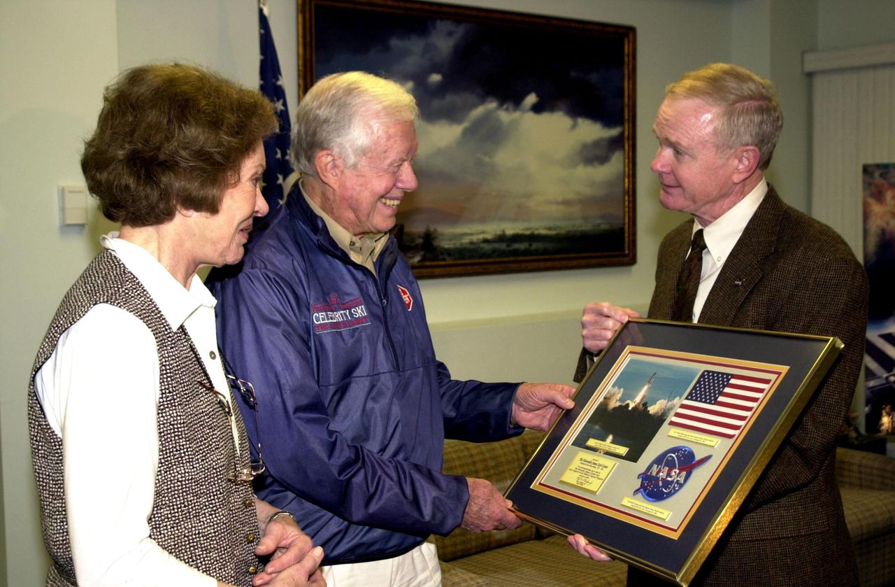 KENNEDY SPACE CENTER, FLA. --  During a visit to Kennedy Space Center, former President Jimmy Carter (center) receives a special presentation from Center Director Roy D. Bridges Jr.  With Carter is his wife, former first lady Rosalyn Carter