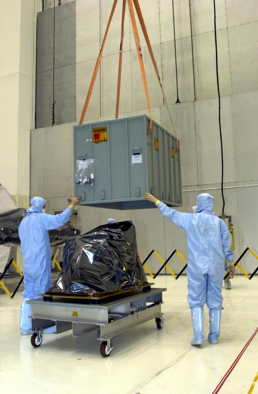 KENNEDY SPACE CENTER, FLA. -- An overhead crane in the Vertical Processing Facility lifts the shipping container from the Near Infrared Camera and Multi-Object Spectrometer (NICMOS) Cooling System, part of the payload on mission STS-109, the Hubble Servicing Telescope Mission. NICMOS is a new experimental cooling system consisting of a compressor and tiny turbines. With the experimental cryogenic system, NASA hopes to re-cool the infrared detectors to below -315 degrees F (-193 degrees Celsius). NICMOS II was previously tested aboard STS-95 in 1998. It could extend the life of the Hubble Space Telescope by several years. Astronauts aboard Columbia on mission STS-109 will be replacing the original NICMOS with the newer version. Launch of mission STS-109 is scheduled for Feb. 28, 2002