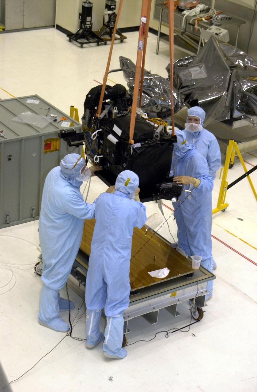 KENNEDY SPACE CENTER, FLA. - A crane in the Vertical Processing Facility lifts the Near Infrared Camera and Multi-Object Spectrometer (NICMOS) Cooling System off the workstand.  NICMOS II is part of the payload on mission STS-109, the Hubble Servicing Telescope Mission.   It is a new experimental cooling system consisting of a compressor and tiny turbines.  With the experimental cryogenic system, NASA hopes to re-cool the infrared detectors to below -315 degrees F (-193 degrees Celsius).  NICMOS II was previously tested aboard STS-95 in 1998. It could extend the life of the Hubble Space Telescope by several years. Astronauts aboard Columbia on mission STS-109 will be replacing the original NICMOS with the newer version.  Launch of mission STS-109 is scheduled for Feb. 28, 2002