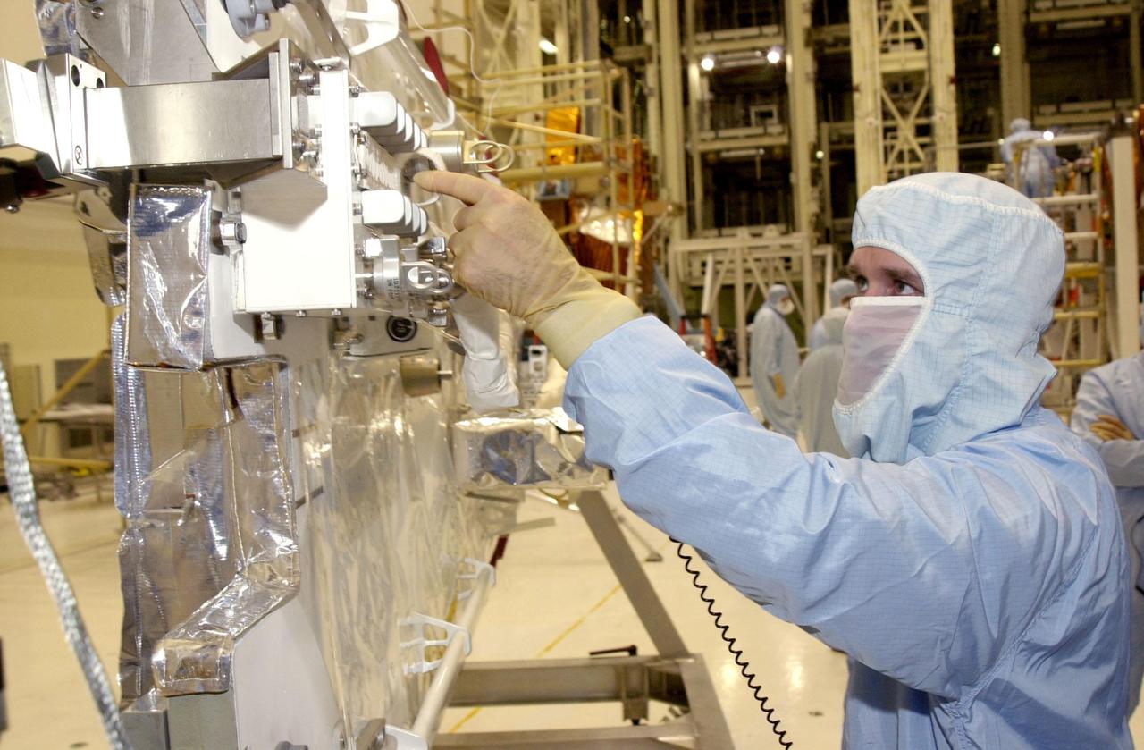 KENNEDY SPACE CENTER, FLA. - In the Vertical Processing Facility, STS-109 Payload Commander John Grunsfeld checks out the NICMOS radiator during crew familiarization activities. Part of the payload on mission STS-109, the Near Infrared Camera and Multi-Object Spectrometer (NICMOS) is a new experimental cooling system consisting of a compressor and tiny turbines. With the experimental cryogenic system, NASA hopes to re-cool the infrared detectors to below -315 degrees F (-193 degrees Celsius). NICMOS II was previously tested aboard STS-95 in 1998. NICMOS could extend the life of the Hubble Space Telescope by several years. Astronauts aboard Columbia on mission STS-109 will be replacing the original NICMOS with the newer version. Launch of Columbia is scheduled Feb. 28, 2002
