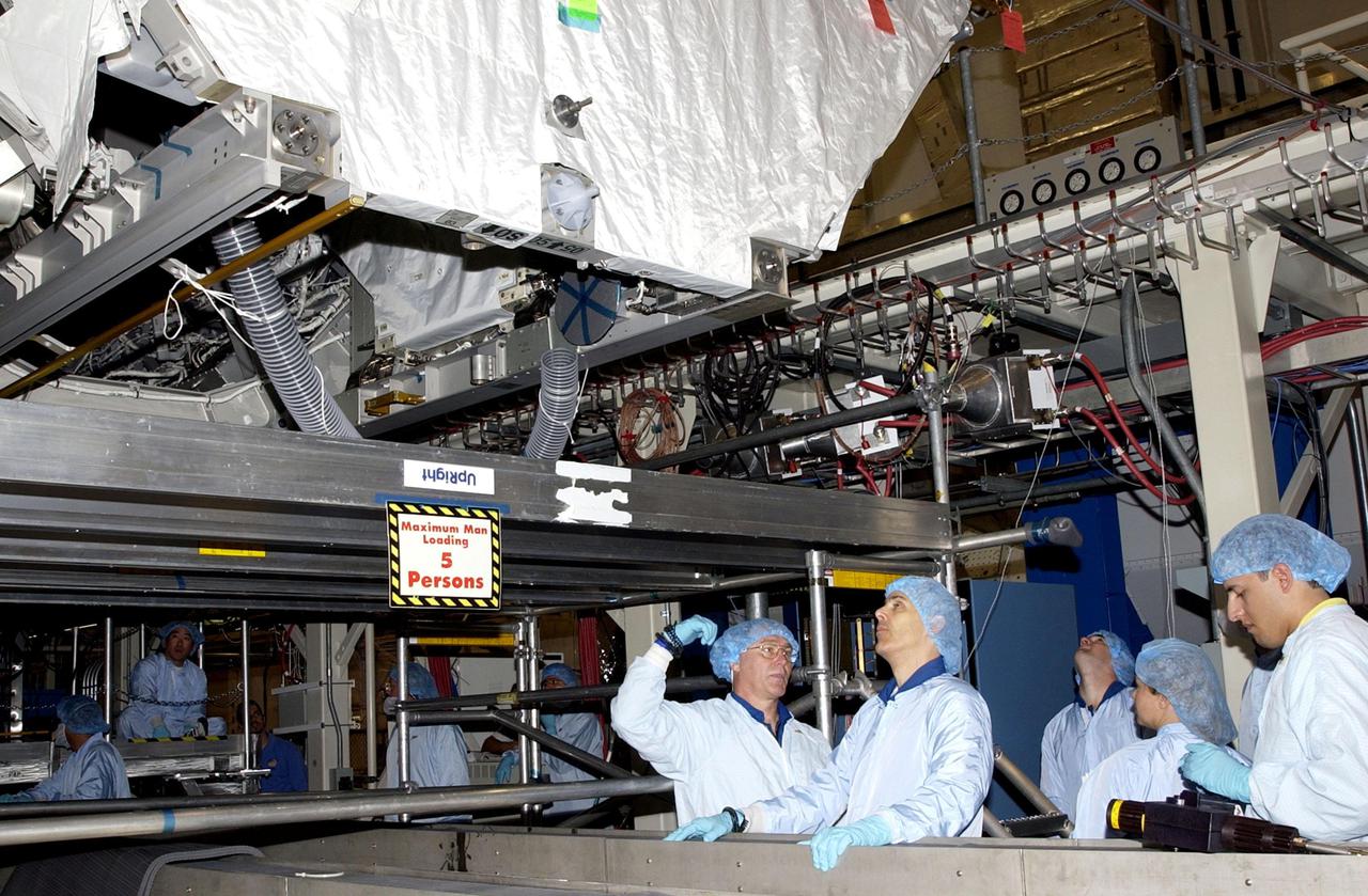 KENNEDY SPACE CENTER, FLA. -- In the Operations and Checkout Building, members of the STS-110 crew check out equipment that will be on their mission.  At center are Mission Specialists Jerry L. Ross and Lee Morin.  Other crew members (not shown) are Commander Michael J. Bloomfield, Pilot Stephen N. Frick, and Mission Specialists Steven L. Smith, Ellen Ochoa and Rex J. Walheim. Part of the payload on the mission is the Integrated Truss Structure S0.  It is the center segment that they will be installing on the International Space Station, part of the 300-foot (91-meter) truss attached to the U.S. Lab. By assembly completion, four more truss segments will attach to either side of the S0 truss.  STS-110 is currently scheduled to launch in April 2002