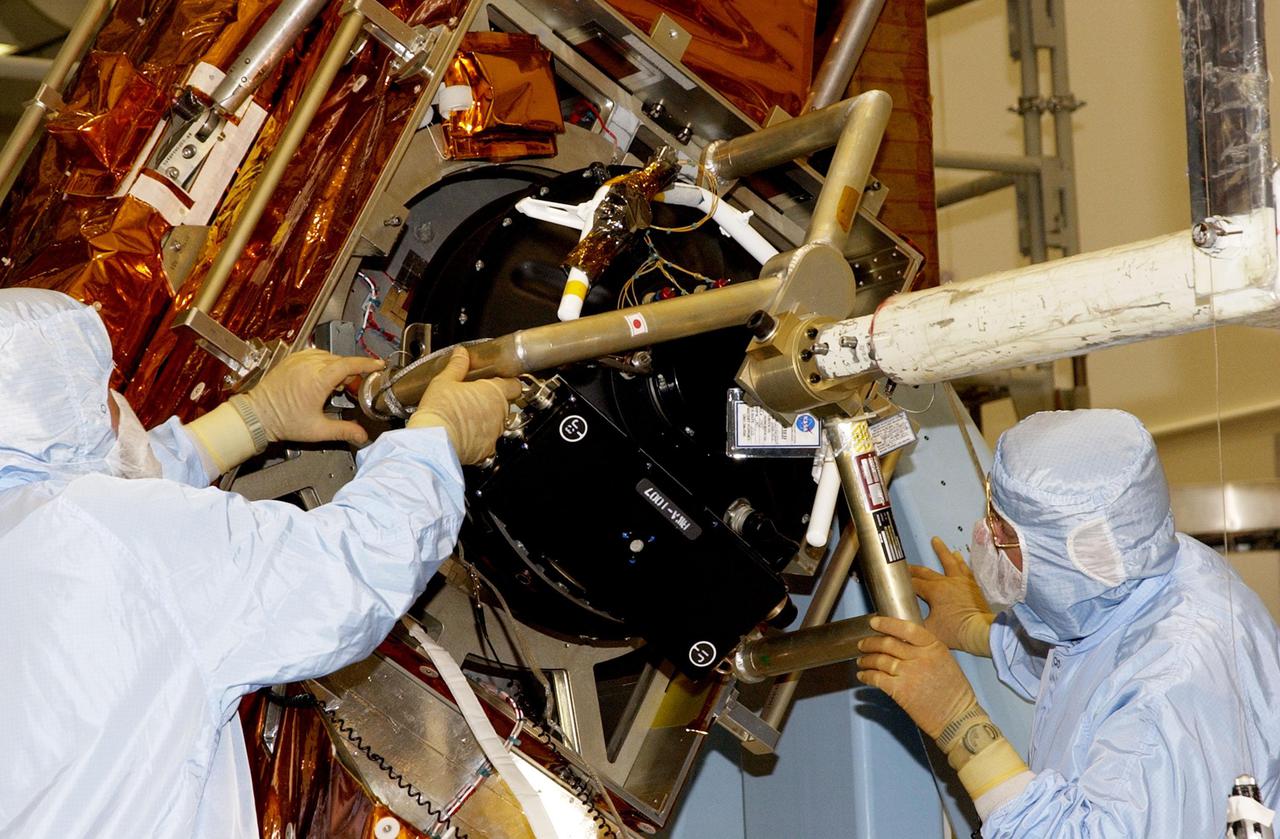 KENNEDY SPACE CENTER, FLA. - Workers in the Vertical Processing Facility check the position of the Hubble Space Telescope's replacement Reaction Wheel Actuator on the Large Orbital Protective Enclosure (LOPE), which is contained in the Multi-Use Lightweight Equipment (MULE) for flight. Part of Hubble's Pointing Control System, the actuators receiving information from sensors and physically adjust Hubble's position and orientation so that Hubble can view the required celestial bodies. The reaction wheels work by rotating a large flywheel up to 3000 rpm or braking it to exchange momentum with the spacecraft which will make Hubble turn. The RWA is part of the payload on mission STS-109, the Hubble Servicing Mission, scheduled to launch Feb. 28, 2002