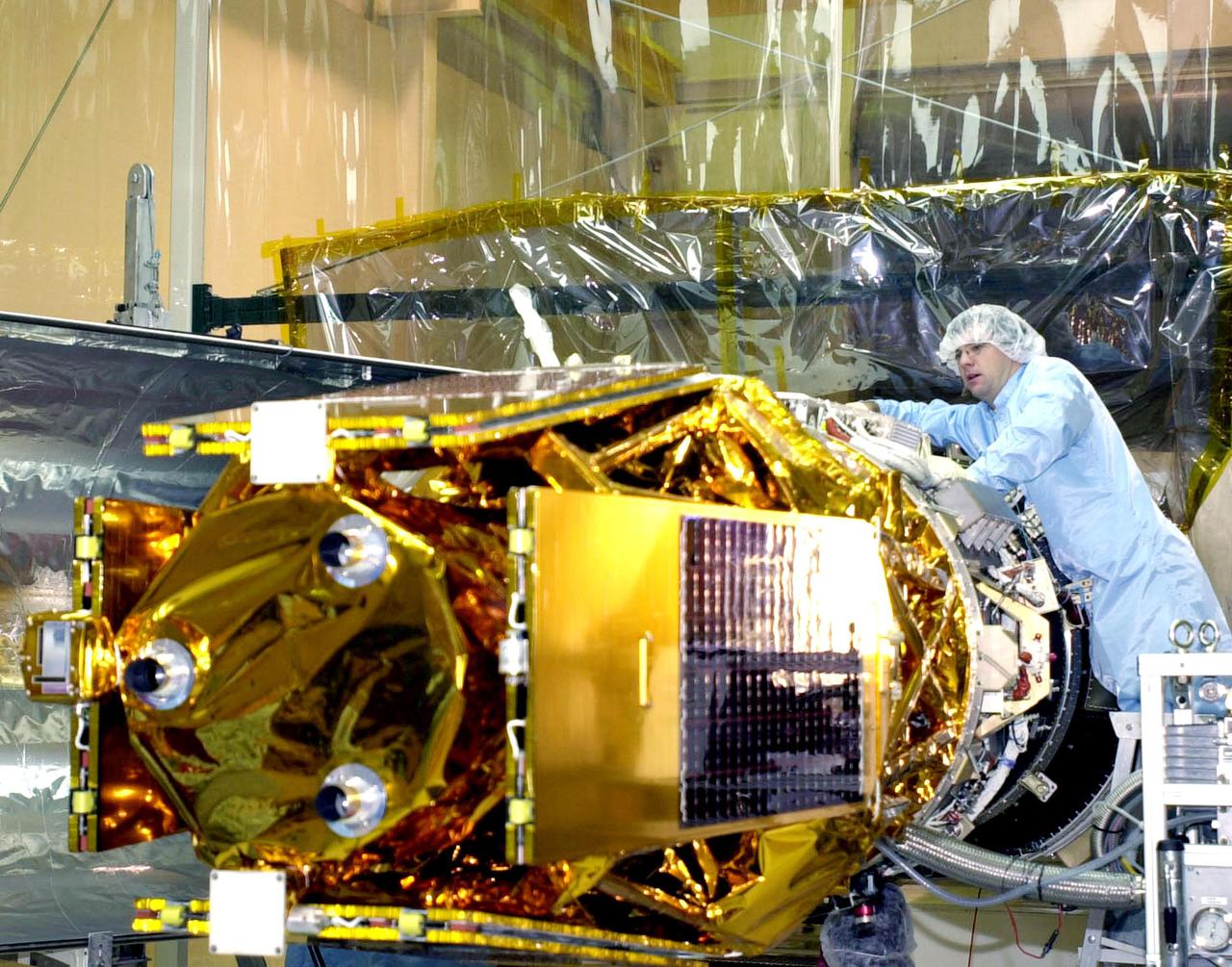 VANDENBERG AFB, CALIF. - A worker prepares the High Energy Solar Spectroscopic Imager (HESSI) for encapsulation atop the Pegasus XL rocket before its transport to Florida. The Pegasus is the vehicle that will launch HESSI on its primary mission to explore the basic physics of particle acceleration and energy release in solar flares. The launch of PegasusXL_HESSI is scheduled for Feb. 5, 2002, from beneath an Orbital Sciences Corp. L-1011 aircraft over the Atlantic Ocean