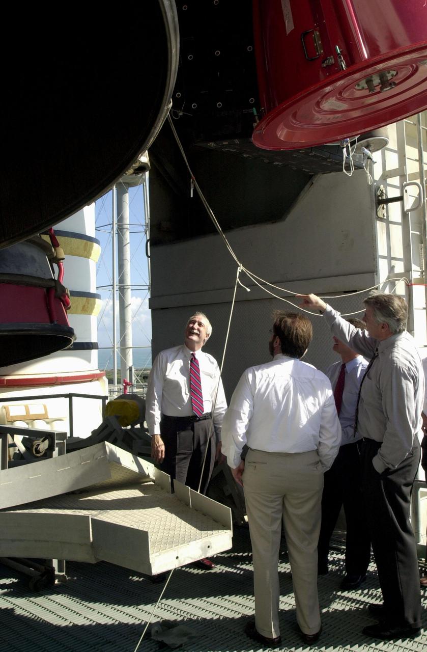 KENNEDY SPACE CENTER, Fla. - Standing beneath Space Shuttle Columbia's main engines, on Launch Pad 39A, the new NASA Administrator Sean O'Keefe (left) gets a close look. Columbia is scheduled to launch Feb. 28 on mission STS-109. The administrator was at KSC on an agencywide familiarization tour of NASA field centers. He was nominated for the position as administrator in November 2001 by President George W. Bush. He was sworn in Dec. 21 as the agency's 10th chief