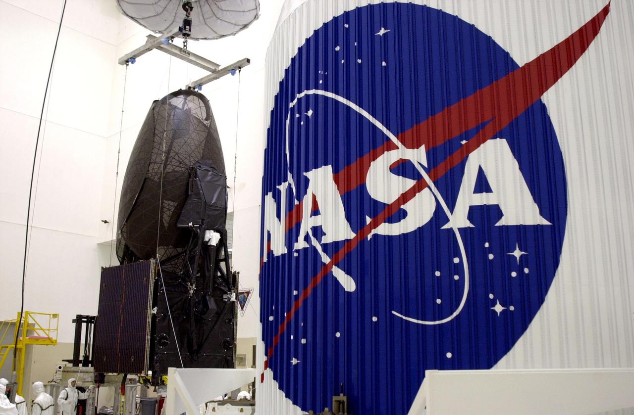 KENNEDY SPACE CENTER, Fla. - The Tracking and Data Relay Satellite-I (TDRS-I) is readied for mating with its nose fairing (in foreground) in the Spacecraft Assembly and Encapsulation Facility-2 (SAEF-2). The second in a new series of telemetry satellites, TDRS-I replenishes the existing on-orbit fleet of six spacecraft. The TDRS System is the primary source of space-to-ground voice, data and telemetry for the Space Shuttle. It also provides communications with the International Space Station and scientific spacecraft in low-Earth orbit such as the Hubble Space Telescope. This new advanced series of satellites will extend the availability of TDRS communications services until about 2017. Launch of TDRS-I is scheduled for March 8 aboard a Lockheed Martin Atlas IIA rocket from Pad 36-A, Cape Canaveral Air Force Station