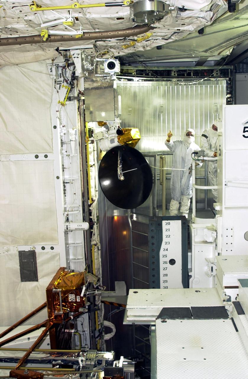 KENNEDY SPACE CENTER, FLA. --   On Launch Pad 39A, members of the STS-109 crew perform a final inspection of the Hubble payload they will deploy on orbit during five spacewalks.  Mission Specialist Nancy Currie is seen pointing at a piece of the equipment.  Other crew members are Commander Scott Altman, Pilot Duane Carey, Payload Commander John Grunsfeld, and Mission Specialists James Newman, Richrd Linnehan and Michael Massimino.  The goal of the mission is to replace Solar Array 2 with Solar Array 3, replace the Power Control Unit, remove the Faint Object Camera and install the Advanced Camera for Surveys (ACS), install the Near Infrared Camera and Multi-Object Spectrometer (NICMOS) Cooling System, and install New Outer Blanket Layer insulation.  Launch of Shuttle Columbia on mission STS-109 is scheduled for Feb. 28 at 6:48 a.m. EST