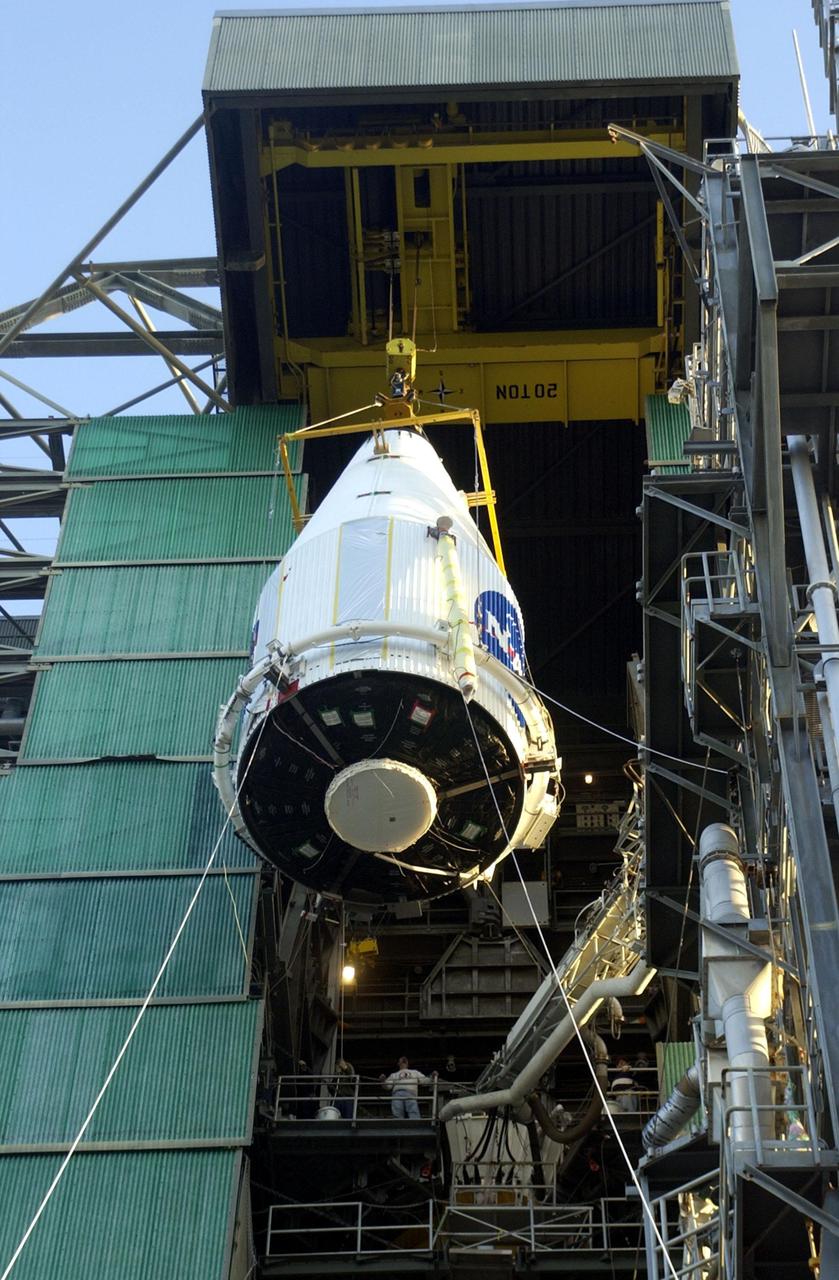 KENNEDY SPACE CENTER, FLA. -- -- The nose fairing encapsulating the Tracking and Data Relay Satellite-I (TDRS-I) nears the top of the launch tower at Pad 36-A, Cape Canaveral Air Force Station, Fla. The fairing will be attached to the Lockheed Martin Atlas IIA rocket for launch. The second in a new series of telemetry satellites, TDRS-I replenishes the existing on-orbit fleet of six spacecraft. The TDRS System is the primary source of space-to-ground voice, data and telemetry for the Space Shuttle. It also provides communications with the International Space Station and scientific spacecraft in low-Earth orbit such as the Hubble Space Telescope. This new advanced series of satellites will extend the availability of TDRS communications services until about 2017. Launch of TDRS-I is scheduled for March 8 between 5:39 - 6:19 p.m. EST