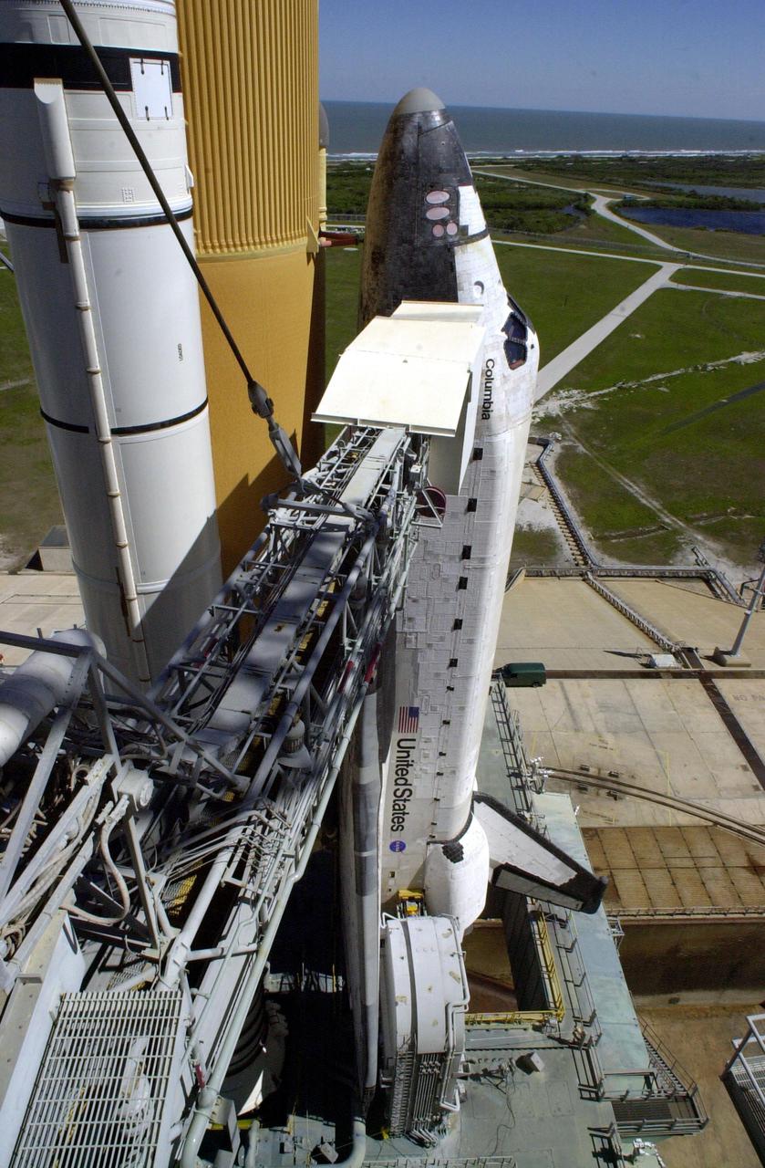 KENNEDY SPACE CENTER, FLA. -- The Rotating Service Structure is rolled back from Space Shuttle Columbia in preparation for launch Feb. 28, 2002, at 6:48 a.m. EST (11:48 GMT) on mission STS-109.  In the photo is seen the Orbiter Access Arm stretched to Columbia's cockpit.  A Hubble Servicing Mission, the goal is to replace Solar Array 2 with Solar Array 3, replace the Power Control Unit, remove the Faint Object Camera and install the ACS, install the Near Infrared Camera and Multi-Object Spectrometer (NICMOS) Cooling System, and install New Outer Blanket Layer insulation.