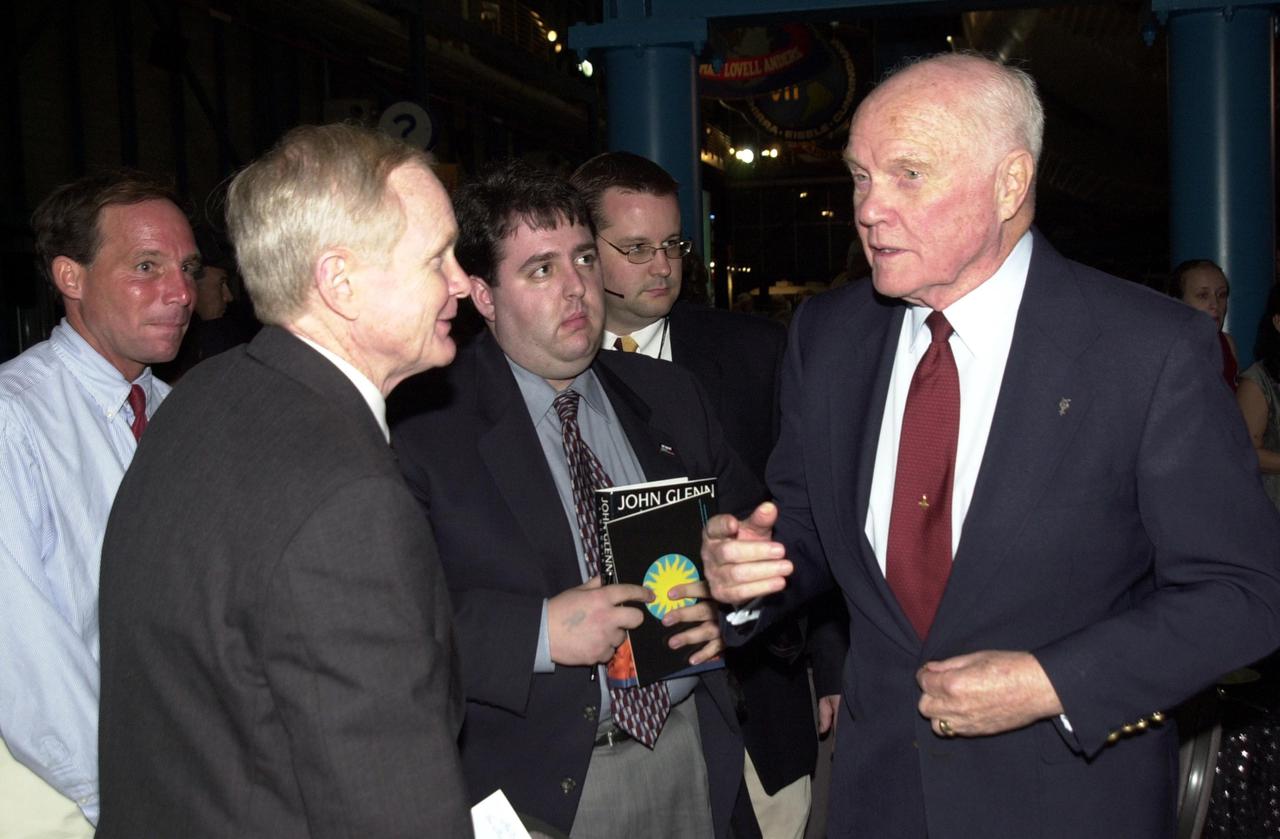 KENNEDY SPACE CENTER, FLA. --  Space pioneer John Glenn Jr. (right) talks with Center Director Roy Bridges Jr. (left) during the celebration of the 40th anniversary of American spaceflight.  The dinner event was held at KSC's Apollo_Saturn V Center