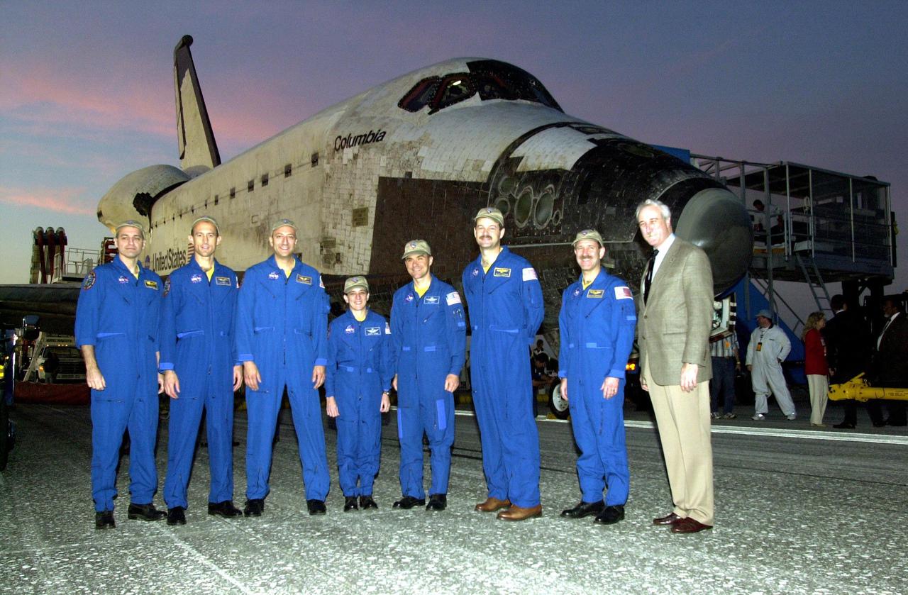 KENNEDY SPACE CENTER, FLA. -- Posing in front of orbiter Columbia is the returning STS-109 crew along with NASA Administrator Sean O'Keefe (right).  From left are Mission Specialists Richard Linnehan, James Newman, Michael Massimino and Nancy Jane Currie; Pilot Duane Carey; Commander Scott Altman; Payload Commander John Grunsfeld; and O'Keefe. The crew returned to Earth after a successful  11-day mission  servicing the Hubble Space Telescope.  Wheel stop occurred on orbit 165 at 4:33:09 a.m. EST.  Main gear touchdown occurred at 4:31:52 a.m. and nose wheel touchdown at 4:32:02.  Rollout time was 1 minute, 17 seconds.   This was the 58th landing at KSC out of 108 missions in the history of the Shuttle program