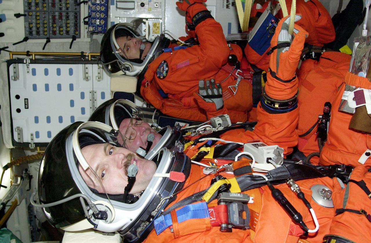 KENNEDY SPACE CENTER, FLA. --  (Left to right) STS-110 Mission Specialists Steven Smith, Jerry Ross and Rex Walheim settle into their seats aboard Space Shuttle Atlantis prior to a simulated launch countdown. The simulation is part of Terminal Countdown Demonstration Test activities.  TCDT also includes emergency egress training and is held at KSC prior to each Space Shuttle flight.  Scheduled for launch April 4, the 11-day mission will feature Shuttle Atlantis docking with the International Space Station (ISS) and delivering the S0 truss, the centerpiece-segment of the primary truss structure that will eventually extend over 300 feet