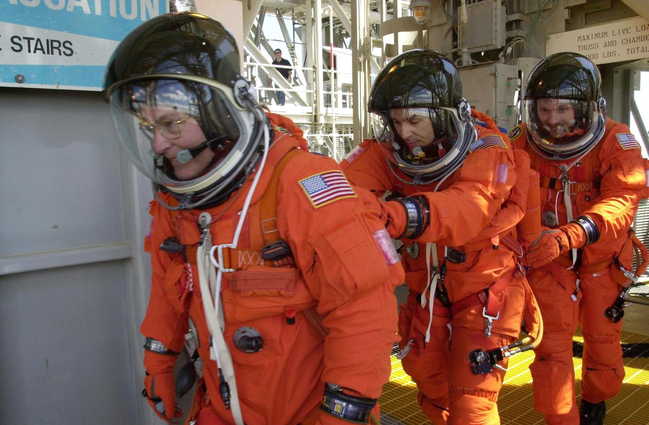 KENNEDY SPACE CENTER, FLA. --   STS-110 crew members practice emergency exit from the Fixed Service Structure during Terminal Countdown Demonstration Test.  From left are Mission Specialists Jerry L. Ross, Lee M.E. Morin and Steven L. Smith.  TCDT also includes a simulated launch countdown and is held at KSC prior to each Space Shuttle flight.  Scheduled for launch April 4, the 11-day mission will feature Shuttle Atlantis docking with the International Space Station (ISS) and delivering the S0 truss, the centerpiece-segment of the primary truss structure that will eventually extend over 300 feet
