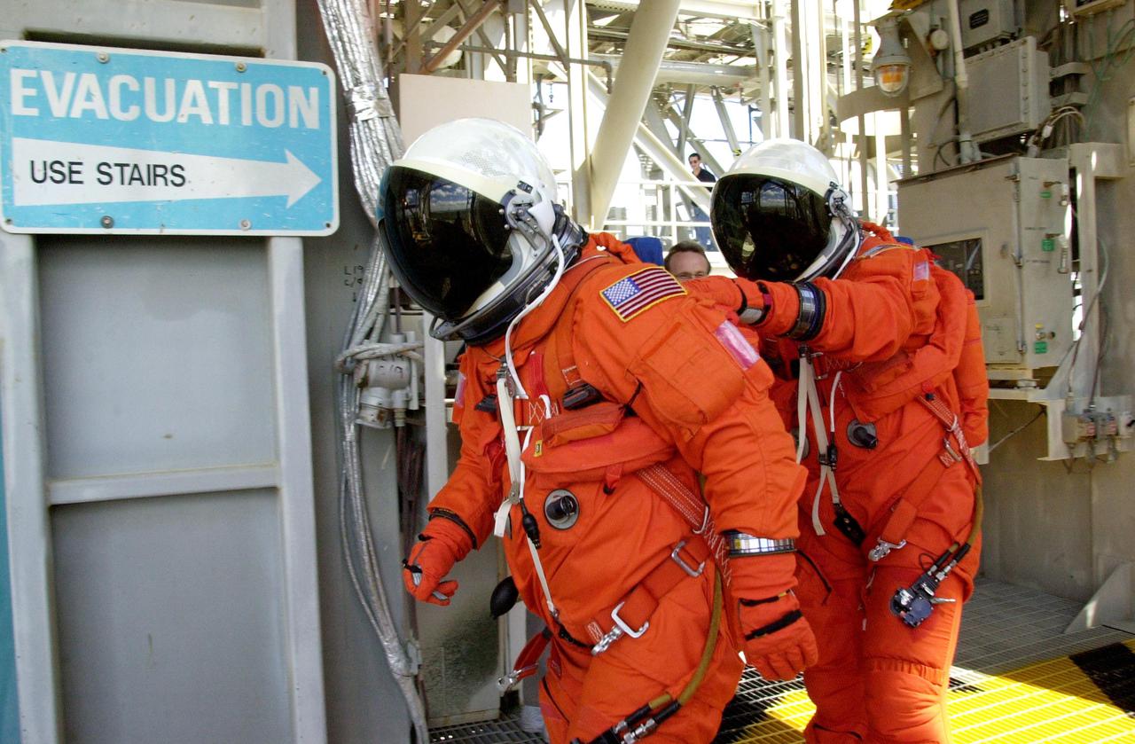 KENNEDY SPACE CENTER, FLA. -- As part of emergency egress training, STS-110 Pilot Stephen N. Frick and Commander Michael J. Bloomfield head for the slidewire basket on the Fixed Service Structure. The crew is taking part in Terminal Countdown Demonstration Test activities, which also include a simulated launch countdown, held at KSC prior to each Space Shuttle flight.  Scheduled for launch April 4, the 11-day mission will feature Shuttle Atlantis docking with the International Space Station (ISS) and delivering the S0 truss, the centerpiece-segment of the primary truss structure that will eventually extend over 300 feet.