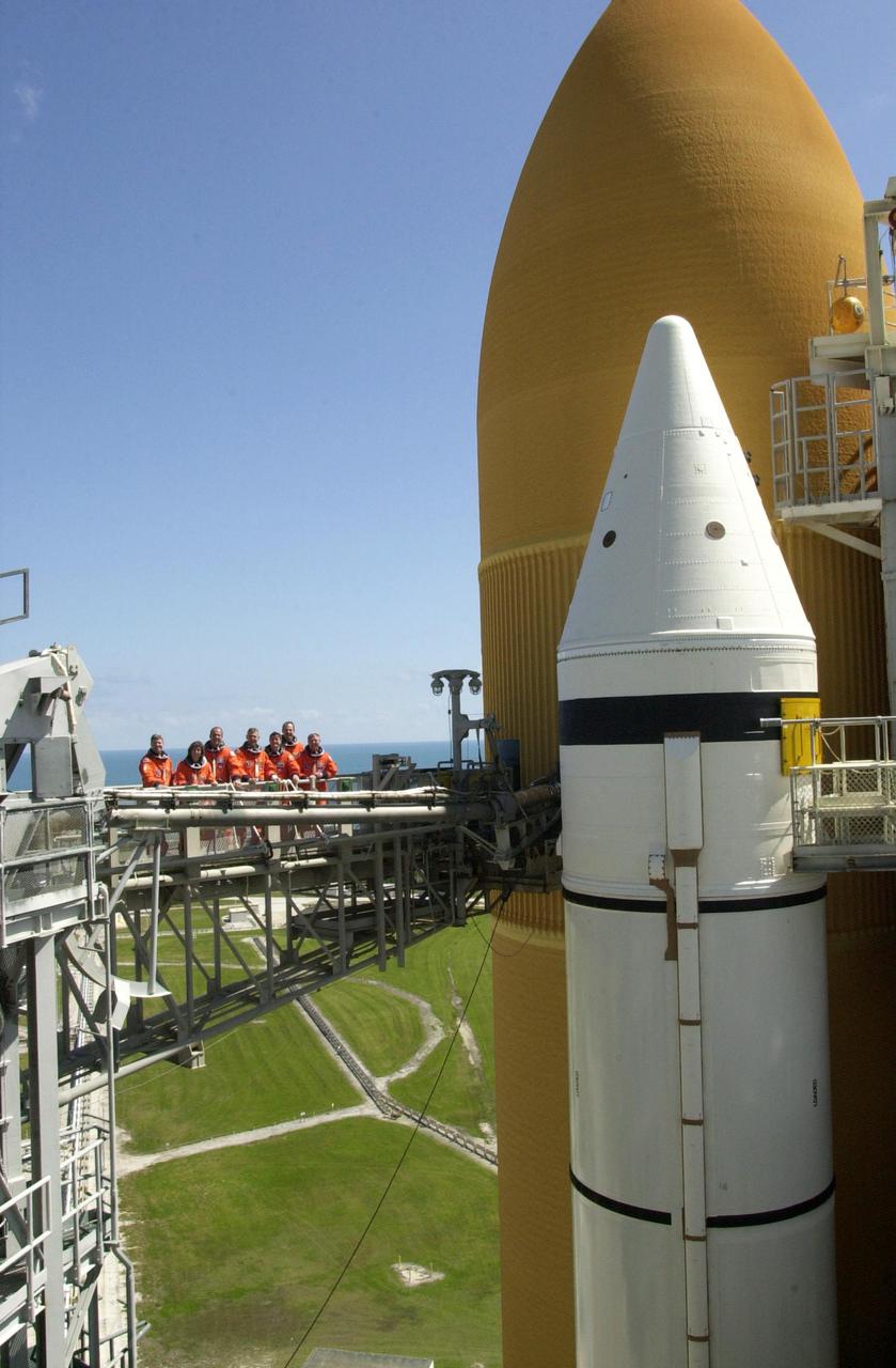KENNEDY SPACE CENTER, FLA. -- The STS-110 crew takes a break on the launch pad during Terminal Countdown Demonstration Test activities to pose for a photo.  Standing left to right are Pilot Stephen Frick, Mission Specialist Ellen Ochoa, Commander Michael Bloomfield, and Mission Specialists Lee Morin, Rex Walheim, Steven Smith and Jerry Ross. The TCDT, which includes emergency egress training and a simulated launch countdown, is held at KSC prior to each Space Shuttle flight.  Scheduled for launch April 4, the 11-day mission will feature Shuttle Atlantis docking with the International Space Station (ISS) and delivering the S0 truss, the centerpiece-segment of the primary truss structure that will eventually extend over 300 feet