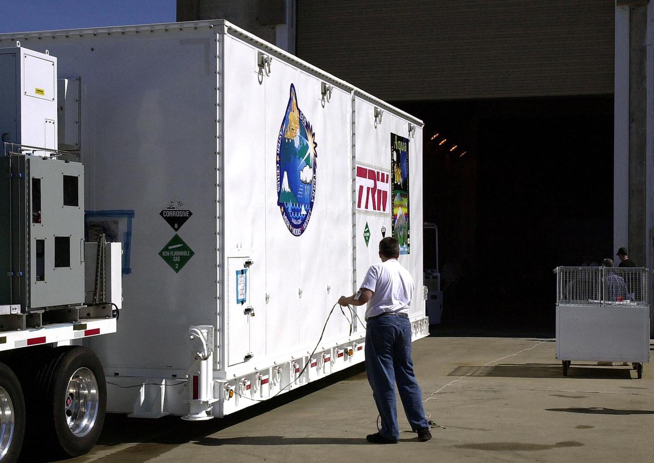 VANDENBERG AFB, CALIF. -- The Aqua-EOS satellite arrives at the Spaceport Systems International (SSI) payload processing facility on South Vandenberg AFB. Aqua will provide a six year chronology of the planet and its processes. Comprehensive measurements taken by its onboard instruments will allow scientists to assess long-term change, identify its human and natural causes and advance the development of models for long-term forecasting. The Focus for the Aqua Project is the multi-disciplinary study of the Earth's Interrelated Processes (atmosphere, oceans, and land surface) and their relationship to earth system changes. The global change research emphasized with the Aqua instrument data sets include: atmospheric temperature and humidity profiles, clouds, precipitation and radiative balance; terrestrial snow and sea ice; sea surface temperature and ocean productivity; soil moisture; and the improvement of numerical weather prediction. Aqua-EOS is scheduled for launch aboard a Delta II 7920-10L vehicle on April 18, 2002