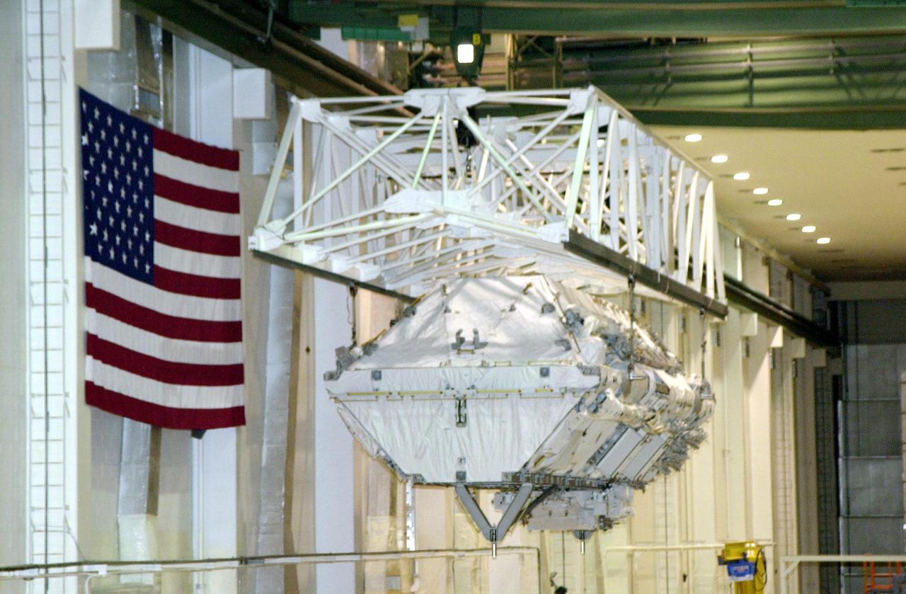 KENNEDY SPACE CENTER, FLA. -- In the Operations and Checkout Building, an overhead crane carries the Integrated Truss Structure S0 from its workstand toward the payload canister.  The S0 truss will be transported to the launch pad for mission STS-110.  Part of the payload, the S0 truss will become the backbone of the orbiting International Space Station (ISS), at the center of the 10-truss, girderlike structure that will ultimately extend the length of a football field on the ISS.   The S0 truss will be attached to the U.S. Lab, 'Destiny,'  on the 11-day mission.    Launch is scheduled for April 4