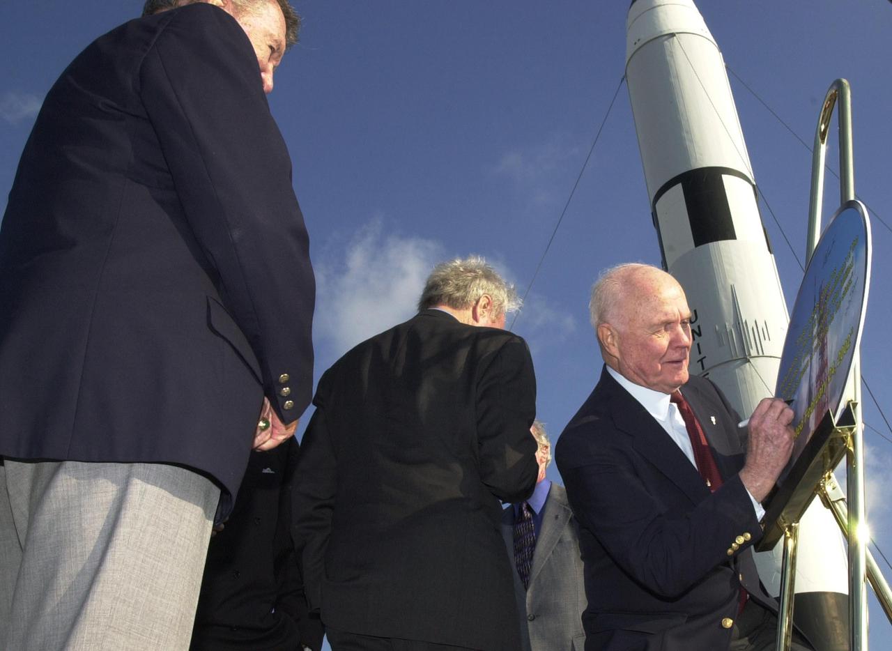 KENNEDY SPACE CENTER, FLA. -- After opening ceremonies for the 40th anniversary celebration of American spaceflight, space pioneer John Glenn Jr., who made that historic flight orbiting the Earth, signs a commemorative painting. The site is the Rocket Garden in the KSC Visitor Complex. Other Mercury astronauts who attended the celebration were Scott Carpenter, Gordon Cooper and Wally Schirra. The event was capped with a dinner held at the KSC Apollo_Saturn V Center.