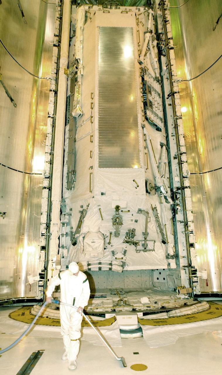 KENNEDY SPACE CENTER, FLA. - A worker at Launch Pad 39B prepares for the closing of Space Shuttle Atlantis' payload bay doors.  The Shuttle payload includes the S0 Integrated Truss Structure (ITS), the Canadian Mobile Transporter, power distribution system modules, a heat pipe radiator for cooling, computers and a pair of rate gyroscopes.  The mission is the 13th assembly flight to the ISS and includes four spacewalks to attach the S0 truss to the U.S. Lab Destiny.  Launch is scheduled for April 4. 