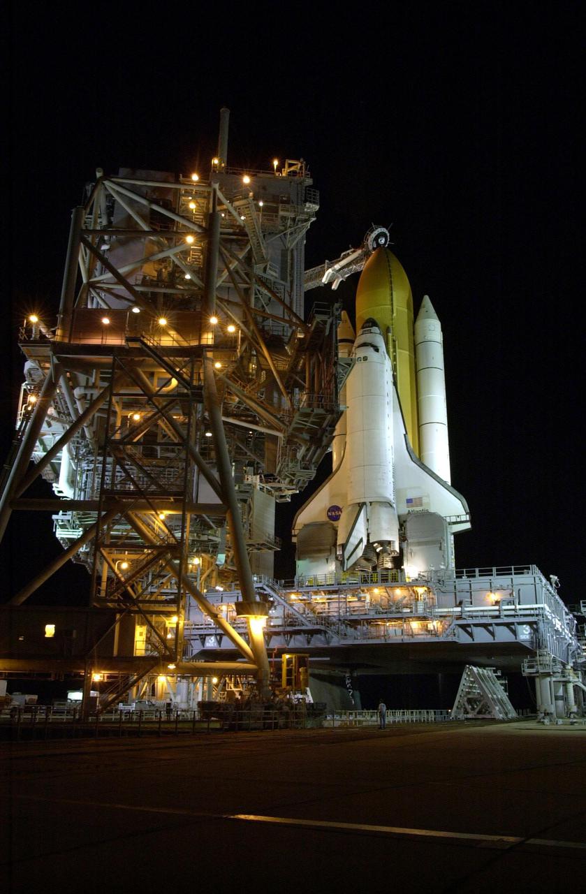 KENNEDY SPACE CENTER, FLA. --  In preparation for launch of Space Shuttle Atlantis on mission STS-110, the Rotating Service Structure (RSS) rolls back into launch position.  The RSS provides protected access to the orbiter for changeout and servicing of payloads at the pad.  The structure has access platforms at five levels to provide access to the payload bay.  The Shuttle rests on the Mobile Launcher Platform (MLP), which straddles the flame trench below.  The flame trench is part of the Flame Deflector System that insulates pad structures from the intense heat of a launch.  Mission STS-110 is scheduled to launch April 4 on its 11-day mission to the International Space Station