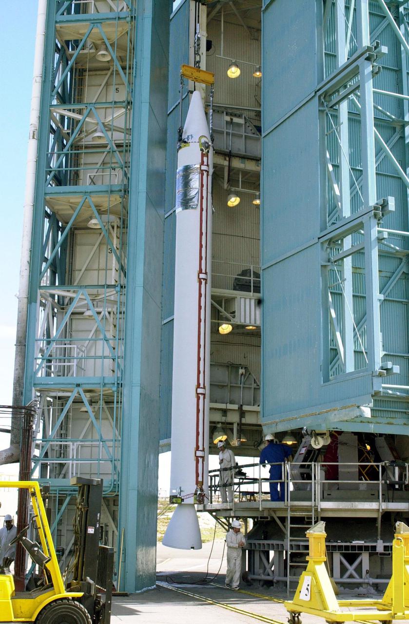 VANDENBERG AFB, CALIF. --  On the launch pad, a solid rocket booster is lifted up the gantry for mating with the Delta II rocket that will launch the Aqua-EOS satellite. Aqua is one of a series of spacebased platforms that are central to NASA's Earth Science Enterprise (ESE), a long-term study of the scope, dynamics and implications of global change. The Aqua program is composed of Aqua and other spacecraft (including Terra and Aura) and a data distribution system (ESDIS, and Mission Operations Center Implementation Team).  Flying  in an orbit that covers the globe every 16 days, Aqua will provide a six-year chronology of the planet and its processes. Comprehensive measurements  taken by its onboard instruments will allow multidisciplinary teams of scientists and researchers from North and South  America, Asia, Australia and Europe to assess long-term  change, identify its human and natural causes and advance the development of models for long-term forecasting.  Launch is scheduled for April 26 from Vandenberg