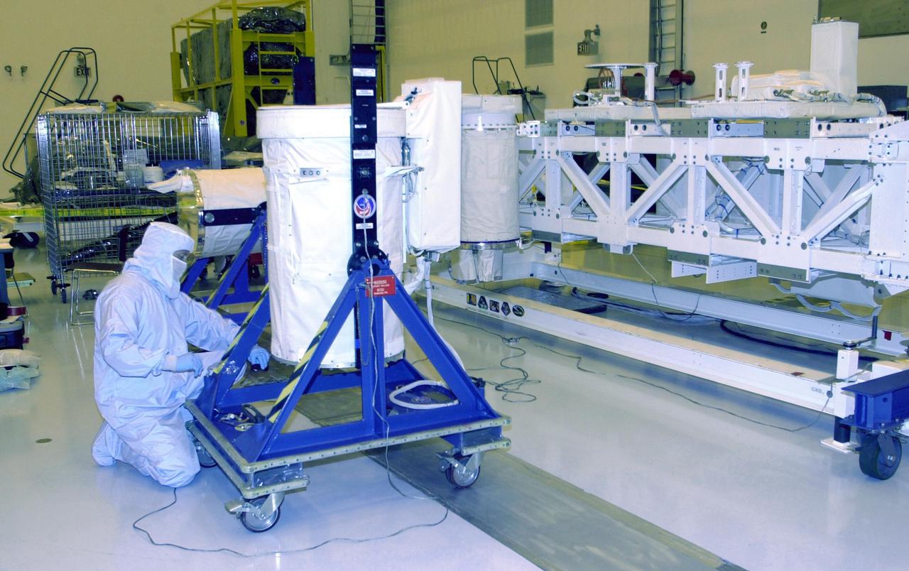 KENNEDY SPACE CENTER, FLA. -- A worker in the Multi-Payload Processing Facility prepares a GetAway Special canister (GAS can) for a move to the Hitchhiker Bridge. The bridge is a carrier for the Fast Reaction Experiments Enabling Science, Technology, Applications and Research (FREESTAR) that incorporates eight high priority secondary attached shuttle experiments on mission STS-107. A research mission, the primary payload is the first flight of the SHI Research Double Module (SHI_RDM), also known as SPACEHAB. The experiments range from material sciences to life sciences (many rats). STS-107 is scheduled to launch July 11, 2002