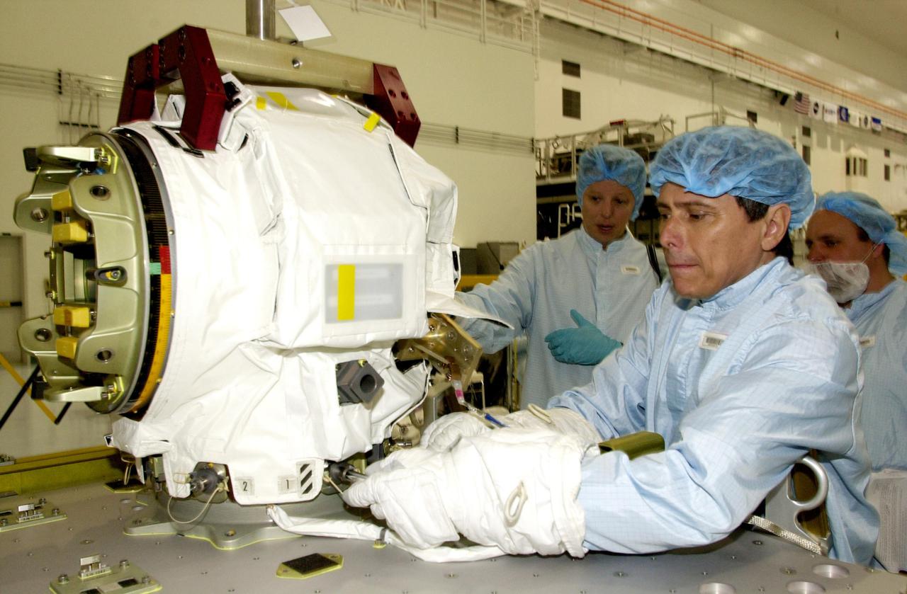 KENNEDY SPACE CENTER, FLA. - STS-111 Mission Specialist Franklin Chang-Diaz (right) practices a maneuver on the replacement pitch roll joint for the SSRMS (Canadarm 2).  The joint will be installed during the mission to the International Space Station.  Part of the payload on mission STS-111 is the Mobile Base System (MBS), which will be installed on the Mobile Transporter to complete the Canadian Mobile Servicing System, or MSS. The mechanical arm will then have the capability to 'inchworm' from the U.S. Lab Destiny to the MSS and travel along the truss to work sites.  STS-111 is the second utilization flight (UF-2) to the Space Station and will also carry the Expedition 5 crew to replace Expedition 4.  Launch is scheduled for May 30, 2002