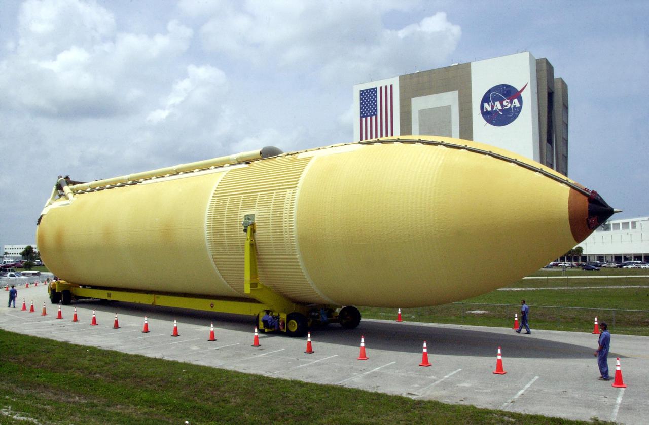 KENNEDY SPACE CENTER, FLA. -- The newly arrived external tank moves slowly on its way the Vehicle Assembly Building (background) where the tank will await stacking for a future Shuttle mission. External tanks are built by the NASA Michoud Assembly Facility in New Orleans and transported by barge to Cape Canaveral and then to the turn basin in the Launch Complex 39 Area