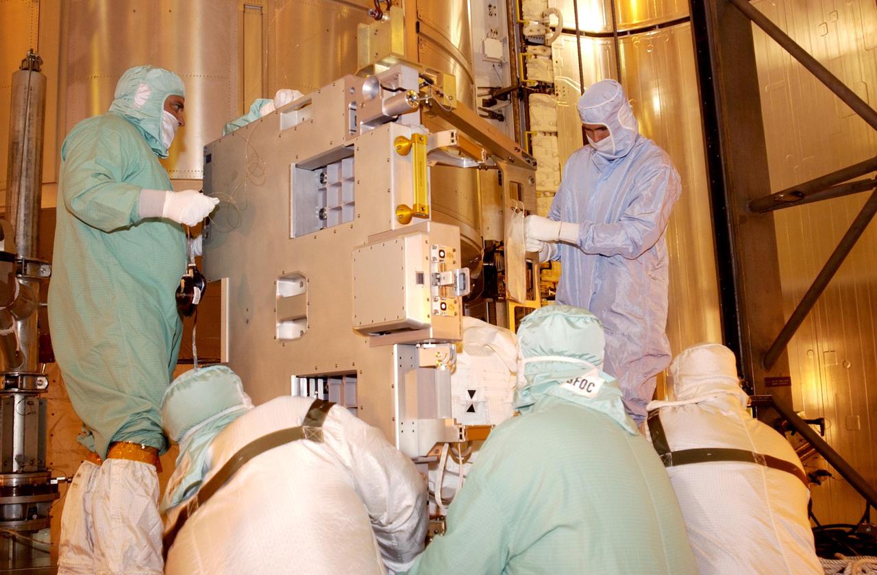 KENNEDY SPACE CENTER, FLA. -- Technicians install the replacement wrist joint for the Space Station Remote Manipulator System into Space Shuttle Endeavour's payload bay. The new wrist joint, called an Orbital Replacement Unit (ORU), will be installed next to the arm's Latching End Effector during the final of three planned spacewalks. Mission STS-111 is designated UF-2, the 14th assembly flight to the International Space Station. Endeavour's payload includes the Multi-Purpose Logistics Module Leonardo and Mobile Base System. The mission also will swap resident crews on the Station, carrying the Expedition 5 crew and returning to Earth Expedition 4. Liftoff of Endeavour is scheduled between 4 and 8 p.m. May 30, 2002