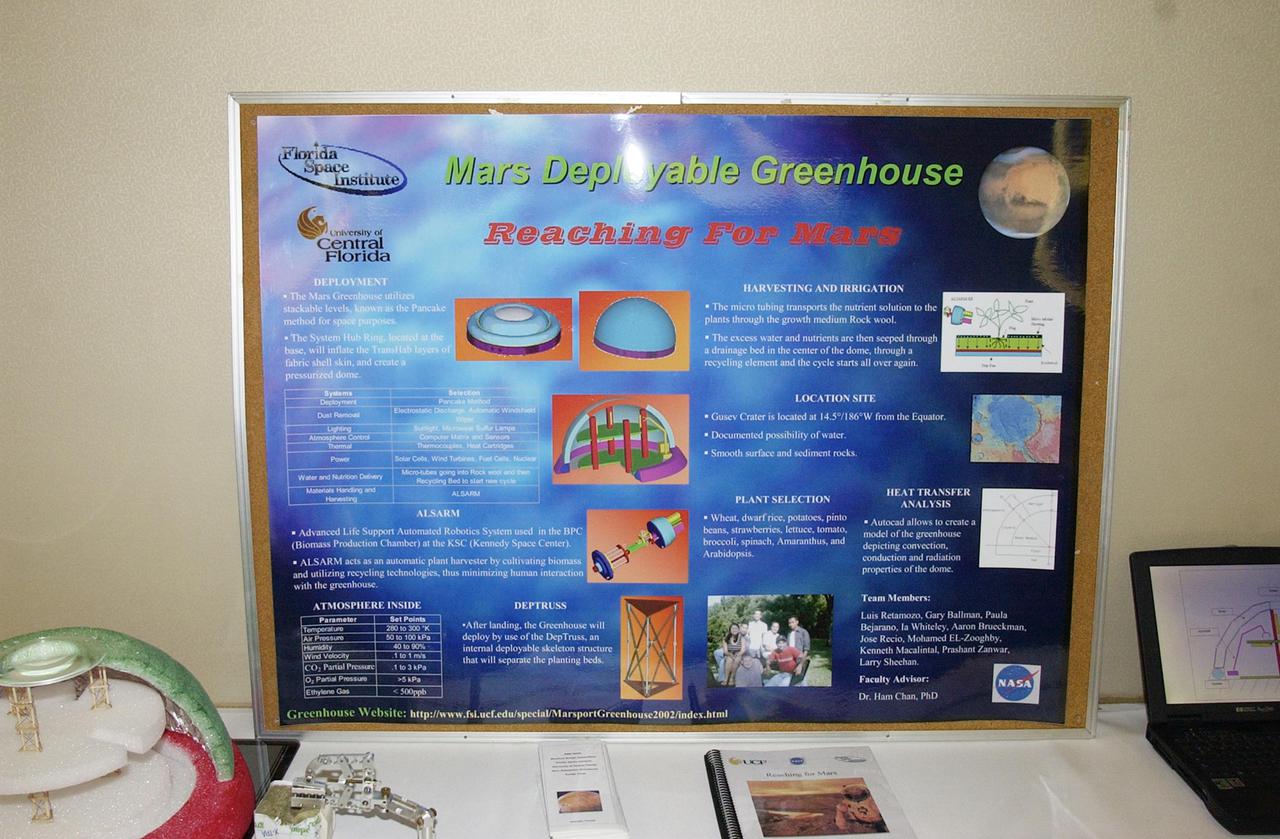 KENNEDY SPACE CENTER, FLA. -- A presentation by the University of Central Florida is on display at the KSC Visitor Complex for this year's NASA MarsPort Engineering Design Student Competition 2002 conference. Participants are presenting papers on engineering trade studies to design optimal configurations for a MarsPort Deployable Greenhouse for operation on the surface of Mars.  Judges in the competition were from KSC, Dynamac Corporation and Florida Institute of Technology.   The winning team's innovative ideas will be used by NASA to evaluate and study other engineering trade concepts.