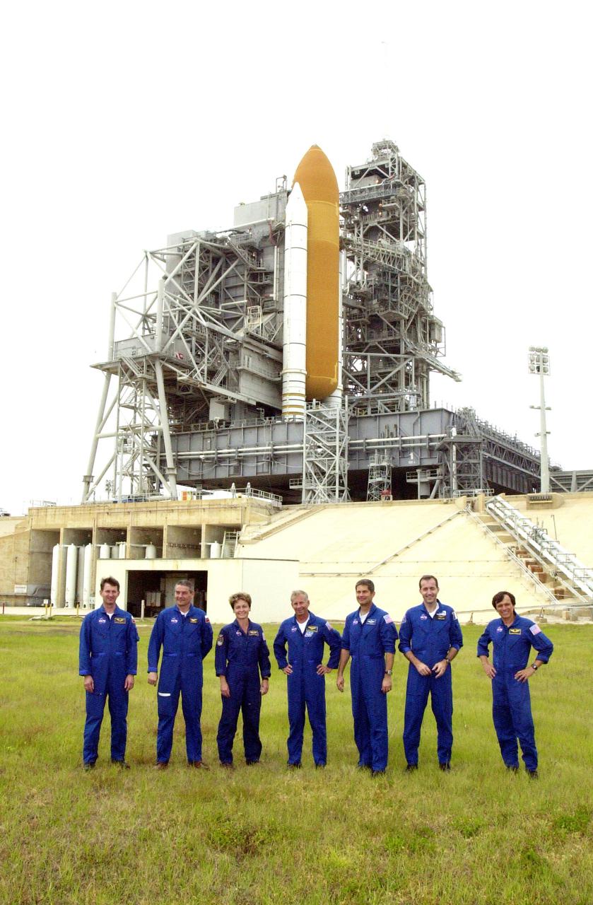 KENNEDY SPACE CENTER, FLA. -- During a break in Terminal Countdown Demonstration Test activities, the STS-111 and Expedition 5 crews gather on Launch Pad 39A for a photo. Standing, left to right, are Expedition 5 crew members Sergei Treschev, Commander Valeri Korzun and Peggy Whitson; STS-111 Commander Kenneth Cockrell, Pilot Paul Lockhart, Mission Specialists Philippe Perrin and Franklin Chang-Diaz. Perrin is with the CNES, the French Space Agency. Expedition 5 will travel to the International Space Station on the mission as the replacement crew for Expedition 4, who will return to Earth aboard the orbiter Endeavour. The crews are taking part in Terminal Countdown Demonstration Test activities at the pad, which include emergency egress training and a simulated launch countdown. The mission is Utilization Flight 2, carrying supplies and equipment to the International Space Station, the Mobile Base System, which will be installed on the Mobile Transporter to complete the Canadian Mobile Servicing System, or MSS, and a replacement wrist_roll joint for Canadarm 2. The mechanical arm will then have the capability to 'inchworm' from the U.S. Lab Destiny to the MSS and travel along the truss to work sites. Launch is scheduled for May 30, 2002