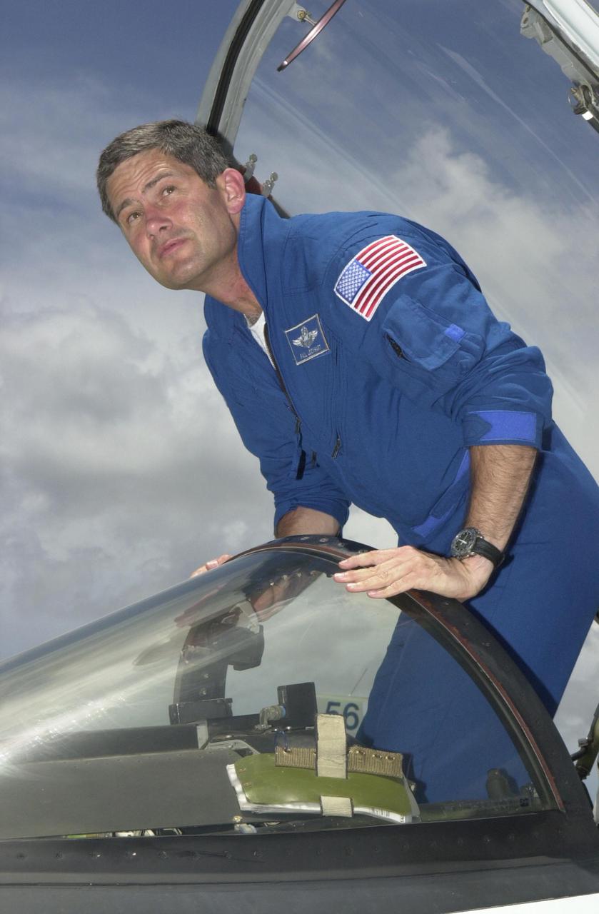 KENNEDY SPACE CENTER, FLA. - At the KSC Shuttle Landing Facility, STS-111 Pilot Paul Lockhart climbs out of the T-38 jet aircraft that he flew from Houston to prepare for launch. Mission STS-111, known as Utilization Flight 2, is carrying supplies and equipment to the International Space Station. The payload includes the Multi-Purpose Logistics Module Leonardo, the Mobile Base System, which will be installed on the Mobile Transporter to complete the Canadian Mobile Servicing System, or MSS, and a replacement wrist_roll joint for Canadarm 2. The mechanical arm will then have the capability to 'inchworm' from the U.S. Lab Destiny to the MSS and travel along the truss to work sites. Also on board will be Expedition 5, traveling to the Station on Space Shuttle Endeavour as the replacement crew for Expedition 4, who will return to Earth aboard the orbiter. Launch is scheduled for May 30, 2002