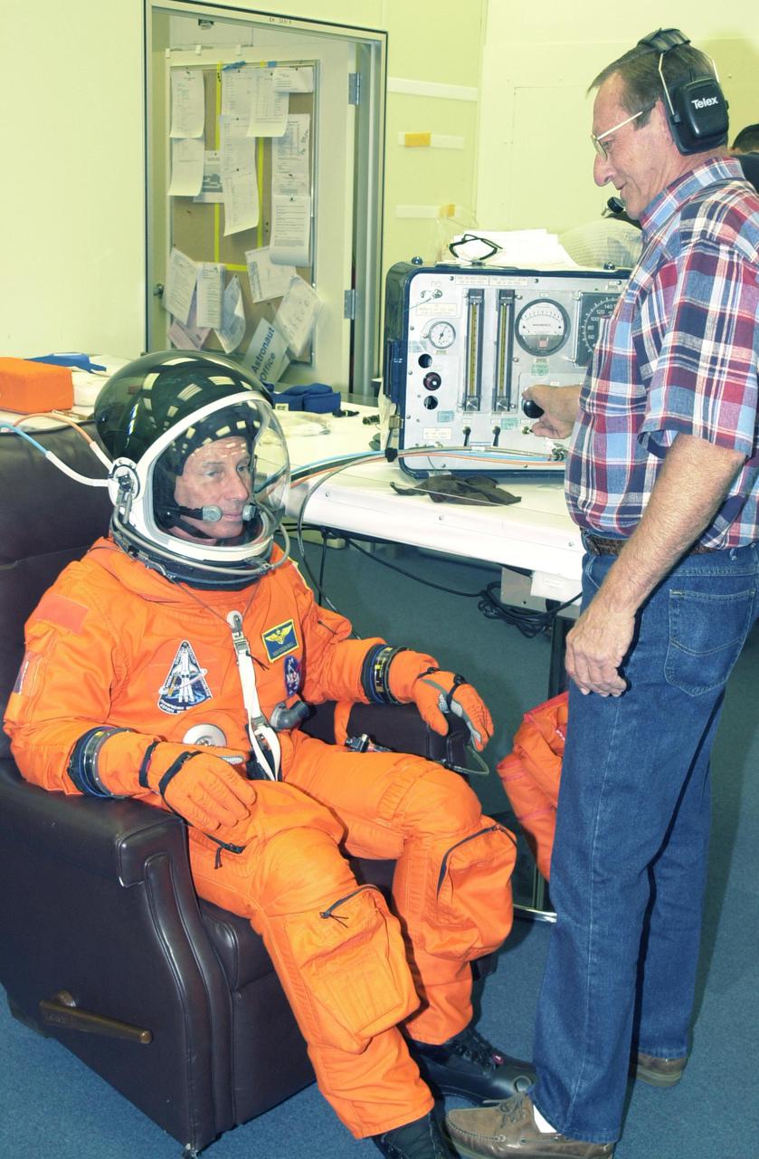 KENNEDY SPACE CENTER, FLA. - STS-111 Commander Kenneth Cockrell concludes suit check, part of pre-launch activities. The mission, known as Utilization Flight 2, is carrying supplies and equipment to the Station. The payload includes the Multi-Purpose Logistics Module Leonardo, the Mobile Base System, which will be installed on the Mobile Transporter to complete the Canadian Mobile Servicing System, or MSS, and a replacement wrist_roll joint for Canadarm 2. The mechanical arm will then have the capability to 'inchworm' from the U.S. Lab Destiny to the MSS and travel along the truss to work sites. Also part of the mission, Expedition 5 will travel to the International Space Station as the replacement crew for Expedition 4, who will return to Earth aboard the orbiter.  Launch is scheduled for May 30, 2002