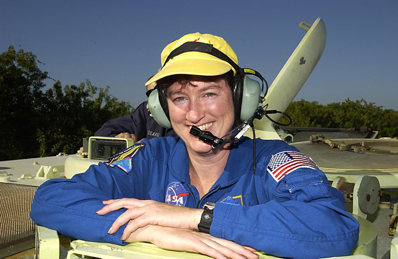 KENNEDY SPACE CENTER, FLA. --  STS-107 Mission Specialist Laurel Clark takes a break during training on the operation of an M113 armored personnel carrier during Terminal Countdown Demonstration Test activities, a standard part of launch preparations.  STS-107 is a mission devoted to research and will include more than 80 experiments that will study Earth and space science, advanced technology development, and astronaut health and safety.  Launch is planned for Jan. 16, 2003, between 10 a.m. and 2 p.m. EST aboard Space Shuttle Columbia.