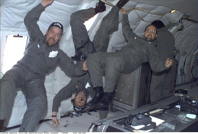 Members of the Water Mist experiment team float in the NASA KC-135 low-g aircraft during preflight tests of the experiment. At center is J. Thomas McKirnon (principal investigator); at right is Angel Abbud-Madrid (co-PI and project scientist). They are with the Center for Commercial Applications of Combustion in Space at the Colorado School of Mines. Water Mist will investigate how best to extinguish flames by using ultrafine droplets of water.