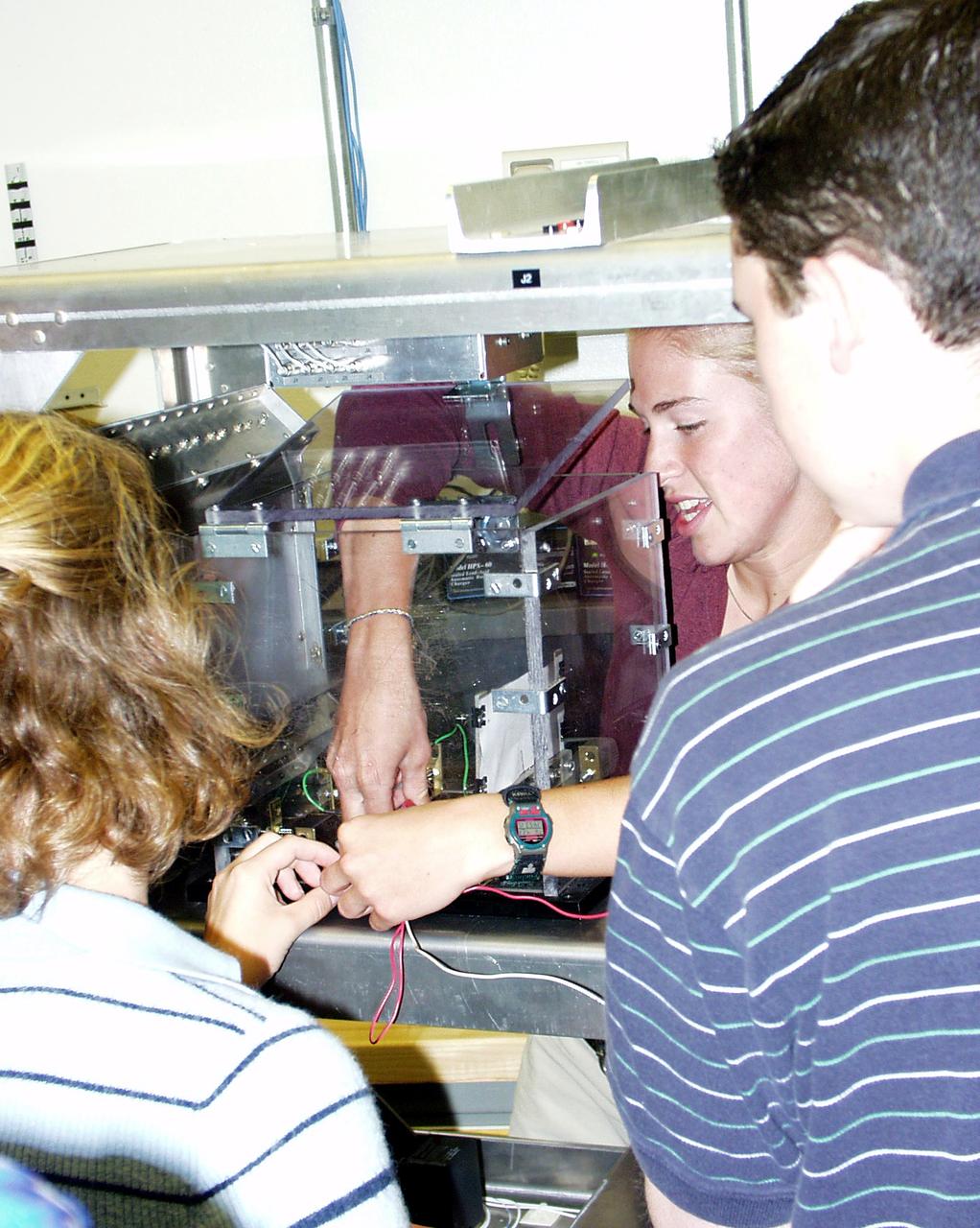 Students prepare their experiment apparatus for free-fall during the second Dropping in a Microgravity Environment (DIME) competition held April 23-25, 2002, at NASA's Glenn Research Center. Competitors included two teams from Sycamore High School, Cincinnati, OH, and one each from Bay High School, Bay Village, OH, and COSI Academy, Columbus, OH. DIME is part of NASA's education and outreach activities. Details are on line at http://microgravity.grc.nasa.gov/DIME_2002.html.