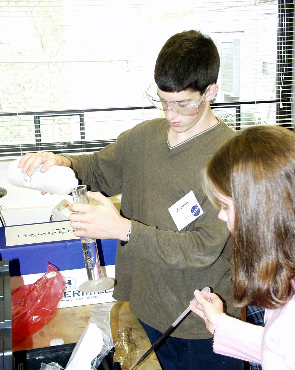 Students prepare to load fluids in their experiment apparatus during the Microgravity Environment (DIME) competition held April 23-25, 2002, at NASA's Glenn Research Center. Competitors included two teams from Sycamore High School, Cincinnati, OH, and one each from Bay High School, Bay Village, OH, and COSI Academy, Columbus, OH. DIME is part of NASA's education and outreach activities. Details are on line at http://microgravity.grc.nasa.gov/DIME_2002.html.