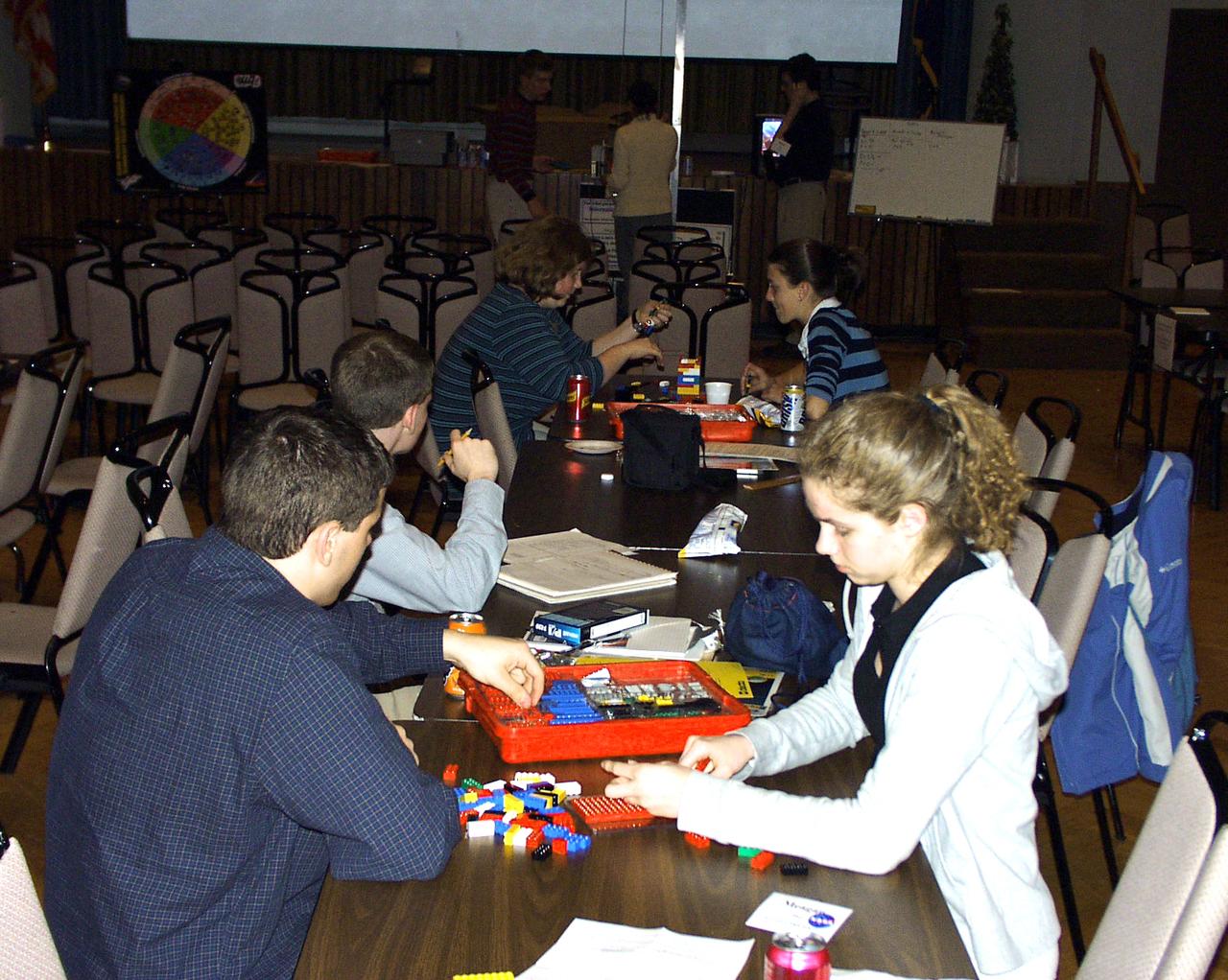Members from all four teams were mixed into pairs to work on a Lego (TM) Challenge device to operate in the portable drop tower demonstrator (background). These two team members are about to try out their LEGO (TM) creation. This was part of the second Dropping in a Microgravity Environment (DIME) competition held April 23-25, 2002, at NASA's Glenn Research Center. Competitors included two teams from Sycamore High School, Cincinnati, OH, and one each from Bay High School, Bay Village, OH, and COSI Academy, Columbus, OH. DIME is part of NASA's education and outreach activities. Details are on line at http://microgravity.grc.nasa.gov/DIME_2002.html.