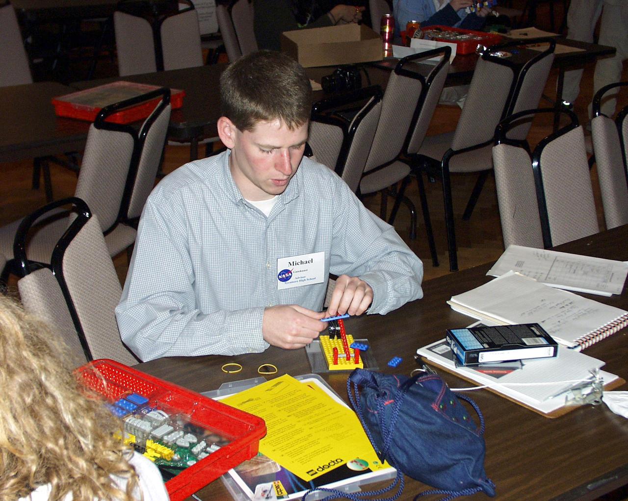A student assembles a Lego (TM) Challenge device designed to operate in the portable drop tower demonstrator as part of the second Dropping in a Microgravity Environment (DIME) competition held April 23-25, 2002, at NASA's Glenn Research Center. Competitors included two teams from Sycamore High School, Cincinnati, OH, and one each from Bay High School, Bay Village, OH, and COSI Academy, Columbus, OH. DIME is part of NASA's education and outreach activities. Details are on line at http://microgravity.grc.nasa.gov/DIME_2002.html.