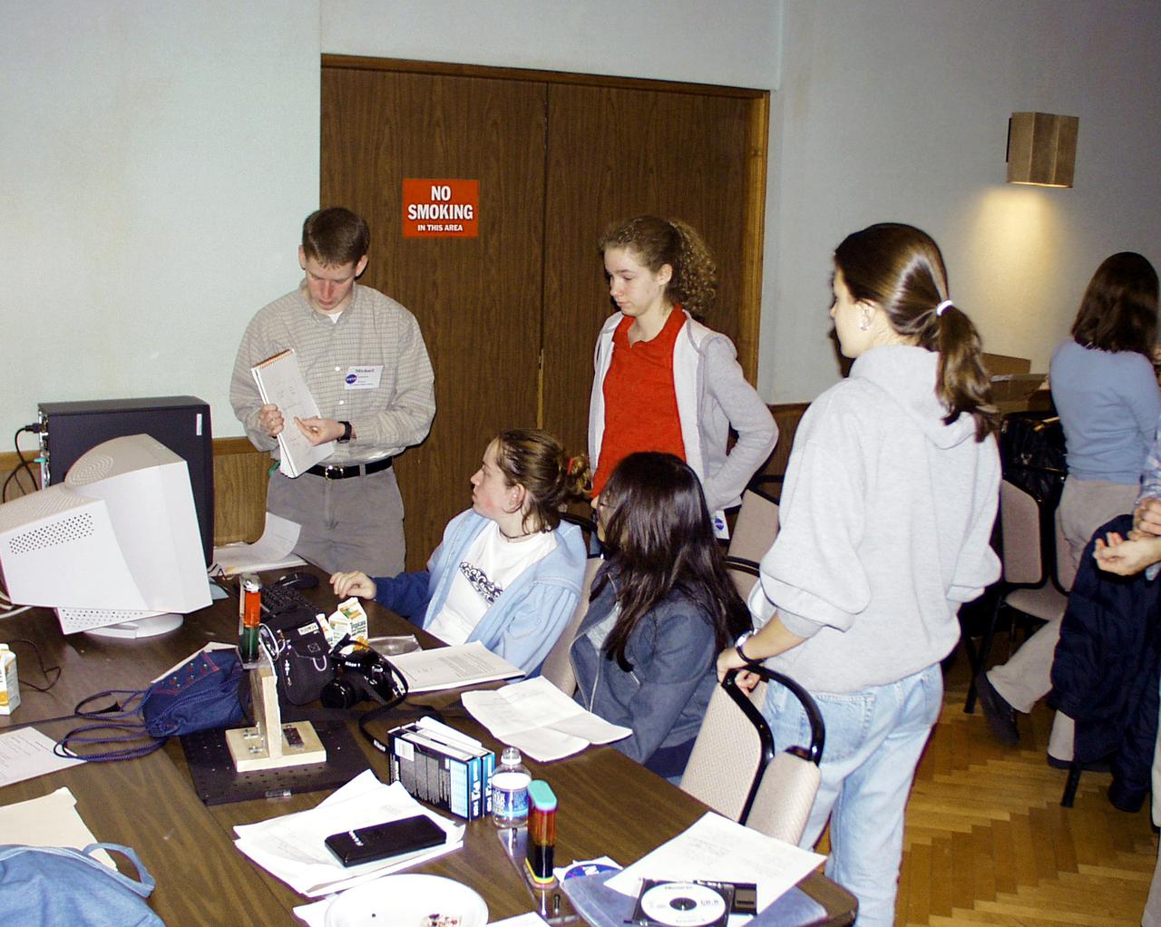 Students discuss fine points of their final design for the Drop Tower experiment during the second Dropping in a Microgravity Environment (DIME) competition held April 23-25, 2002, at NASA's Glenn Research Center. Competitors included two teams from Sycamore High School, Cincinnati, OH, and one each from Bay High School, Bay Village, OH, and COSI Academy, Columbus, OH. DIME is part of NASA's education and outreach activities. Details are on line at http://microgravity.grc.nasa.gov/DIME_2002.html.