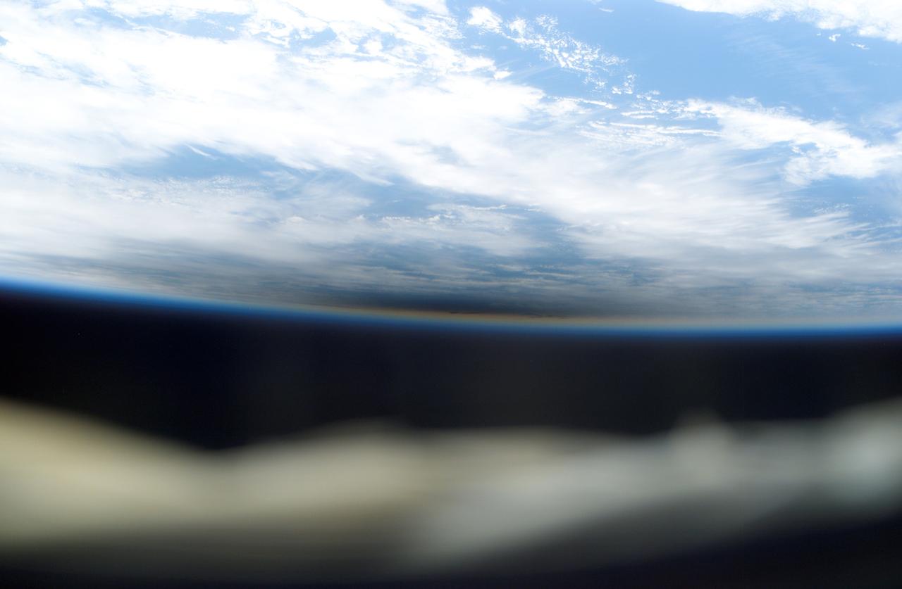 International Space Station (ISS) crew members were able to document a rare occurrence. The dark area near the center of the frame is actually a shadow cast by the moon during the total solar eclipse of December 4, 2002. The shadow obscures an area of cloud cover. The Station, with three Expedition Six crew members aboard, was over the Indian Ocean at the time of the eclipse.