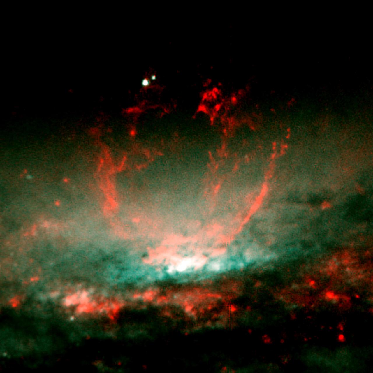 NASA's Hubble Space Telescope (HST) captures a lumpy bubble of hot gas rising from a cauldron of glowing matter in Galaxy NGC 3079, located 50 million light-years from Earth in the constellation Ursa Major. Astronomers suspect the bubble is being blown by "winds" or high speed streams of particles, released during a burst of star formation. The bubble's lumpy surface has four columns of gaseous filaments towering above the galaxy's disc that whirl around in a vortex and are expelled into space. Eventually, this gas will rain down on the disc and may collide with gas clouds, compress them, and form a new generation of stars.