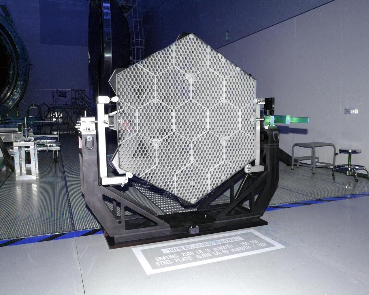 This photo (a frontal view) is of one of many segments of the Eastman-Kodak mirror assembly being tested for the James Webb Space Telescope (JWST) project at the X-Ray Calibration Facility at Marshall Space Flight Center (MSFC). MSFC is supporting Goddard Space Flight Center (GSFC) in developing the JWST by taking numerous measurements to predict its future performance. The tests are conducted in a vacuum chamber cooled to approximate the super cold temperatures found in space. During its 27 years of operation, the facility has performed testing in support of a wide array of projects, including the Hubble Space Telescope (HST), Solar A, Chandra technology development, Chandra High Resolution Mirror Assembly and science instruments, Constellation X-Ray Mission, and Solar X-Ray Imager, currently operating on a Geostationary Operational Environment Satellite. The JWST is NASA's next generation space telescope, a successor to the Hubble Space Telescope, named in honor of NASA's second administrator, James E. Webb. It is scheduled for launch in 2010 aboard an expendable launch vehicle. It will take about 3 months for the spacecraft to reach its destination, an orbit of 940,000 miles in space.