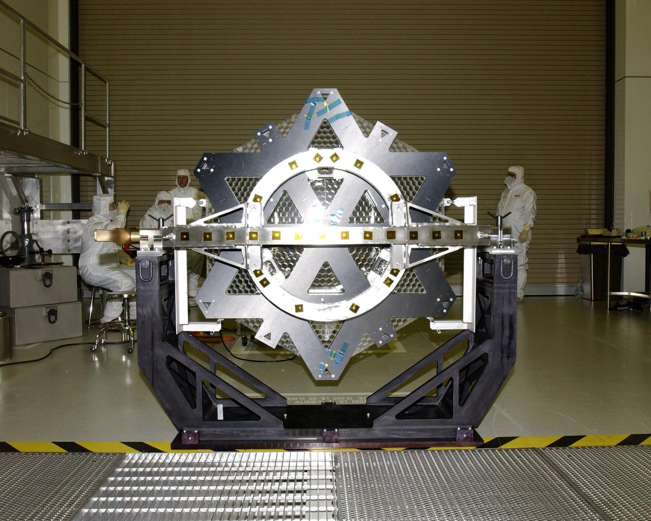 This photo (rear view) is of one of many segments of the Eastman-Kodak mirror assembly being tested for the James Webb Space Telescope (JWST) project at the X-Ray Calibration Facility at Marshall Space Flight Center (MSFC). MSFC is supporting Goddard Space Flight Center (GSFC) in developing the JWST by taking numerous measurements to predict its future performance. The tests are conducted in a vacuum chamber cooled to approximate the super cold temperatures found in space. During its 27 years of operation, the facility has performed testing in support of a wide array of projects, including the Hubble Space Telescope (HST), Solar A, Chandra technology development, Chandra High Resolution Mirror Assembly and science instruments, Constellation X-Ray Mission, and Solar X-Ray Imager, currently operating on a Geostationary Operational Environment Satellite. The JWST is NASA's next generation space telescope, a successor to the Hubble Space Telescope, named in honor of NASA's second administrator, James E. Webb. It is scheduled for launch in 2010 aboard an expendable launch vehicle. It will take about 3 months for the spacecraft to reach its destination, an orbit of 940,000 miles in space.